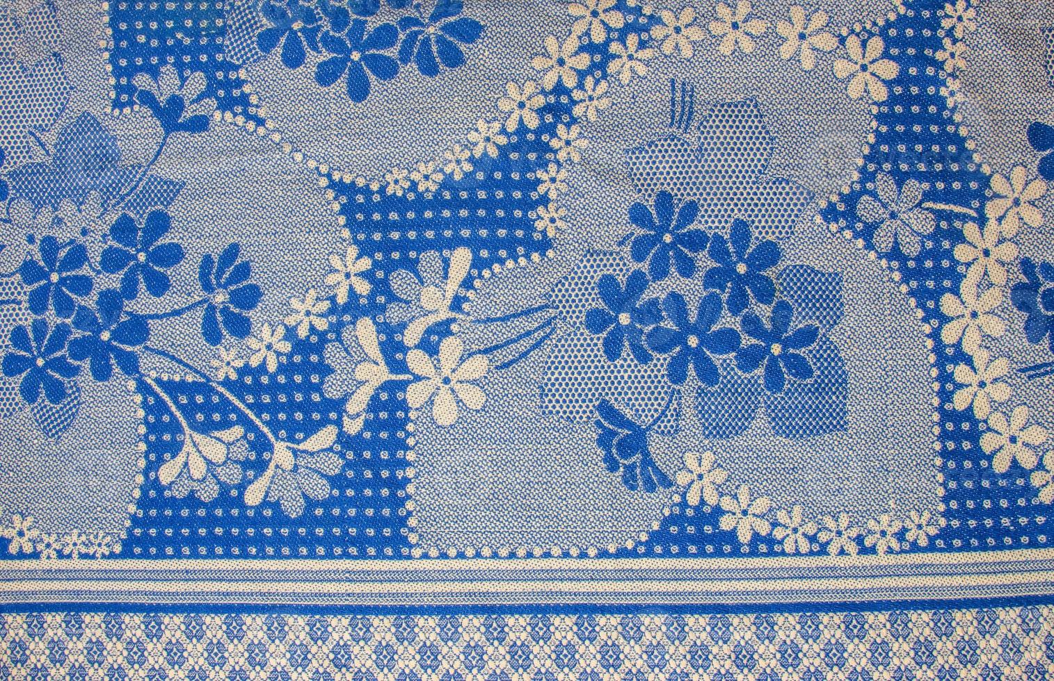 A fragment of the texture of a white-blue tablecloth made in the 1960s in Ukraine. Traditional national ornament. photo