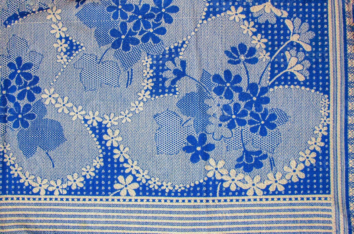 A fragment of the texture of a white-blue tablecloth made in the 1960s in Ukraine. Traditional national ornament. photo