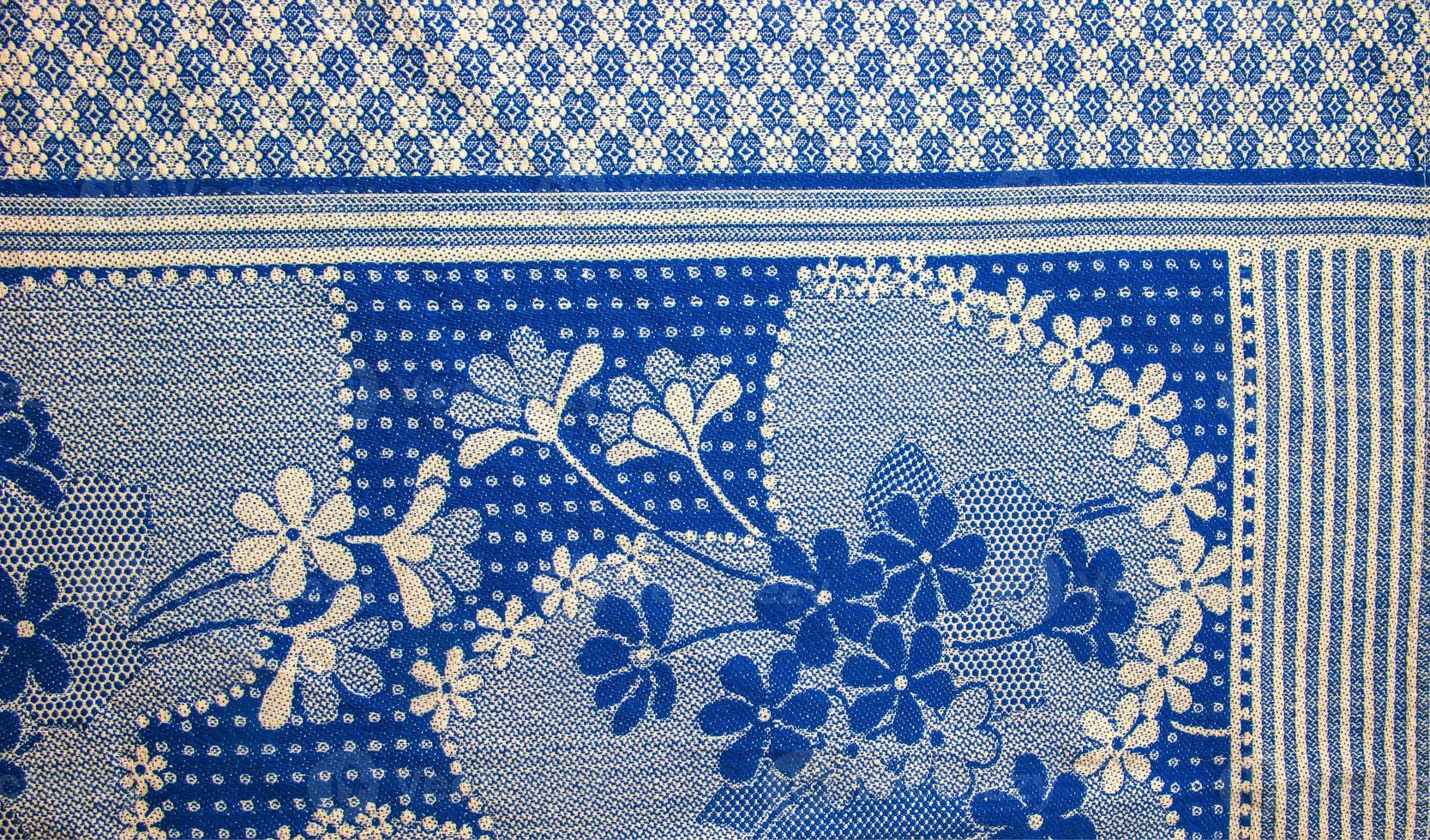 A fragment of the texture of a white-blue tablecloth made in the 1960s in Ukraine. Traditional national ornament. photo