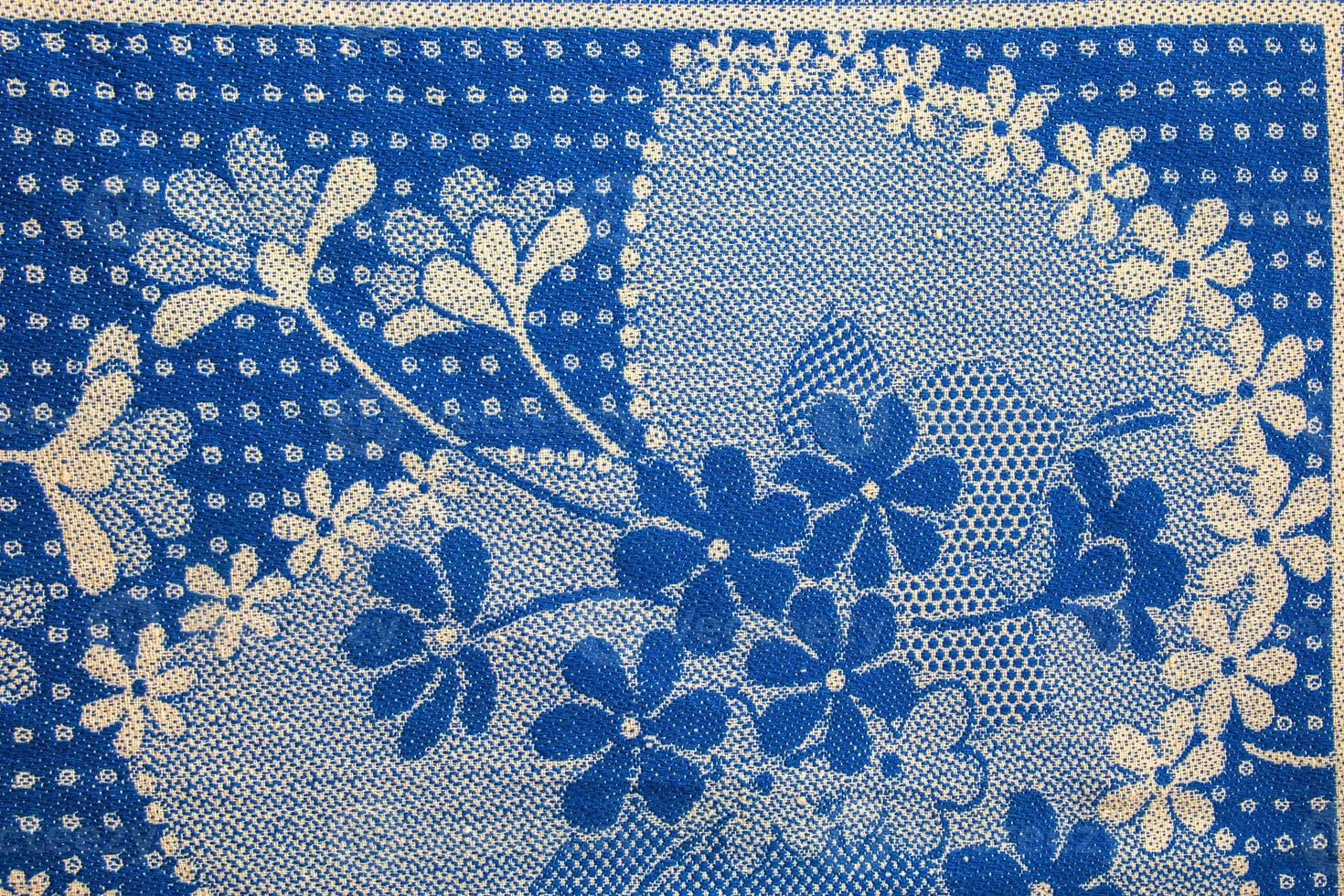 A fragment of the texture of a white-blue tablecloth made in the 1960s in Ukraine. Traditional national ornament. photo