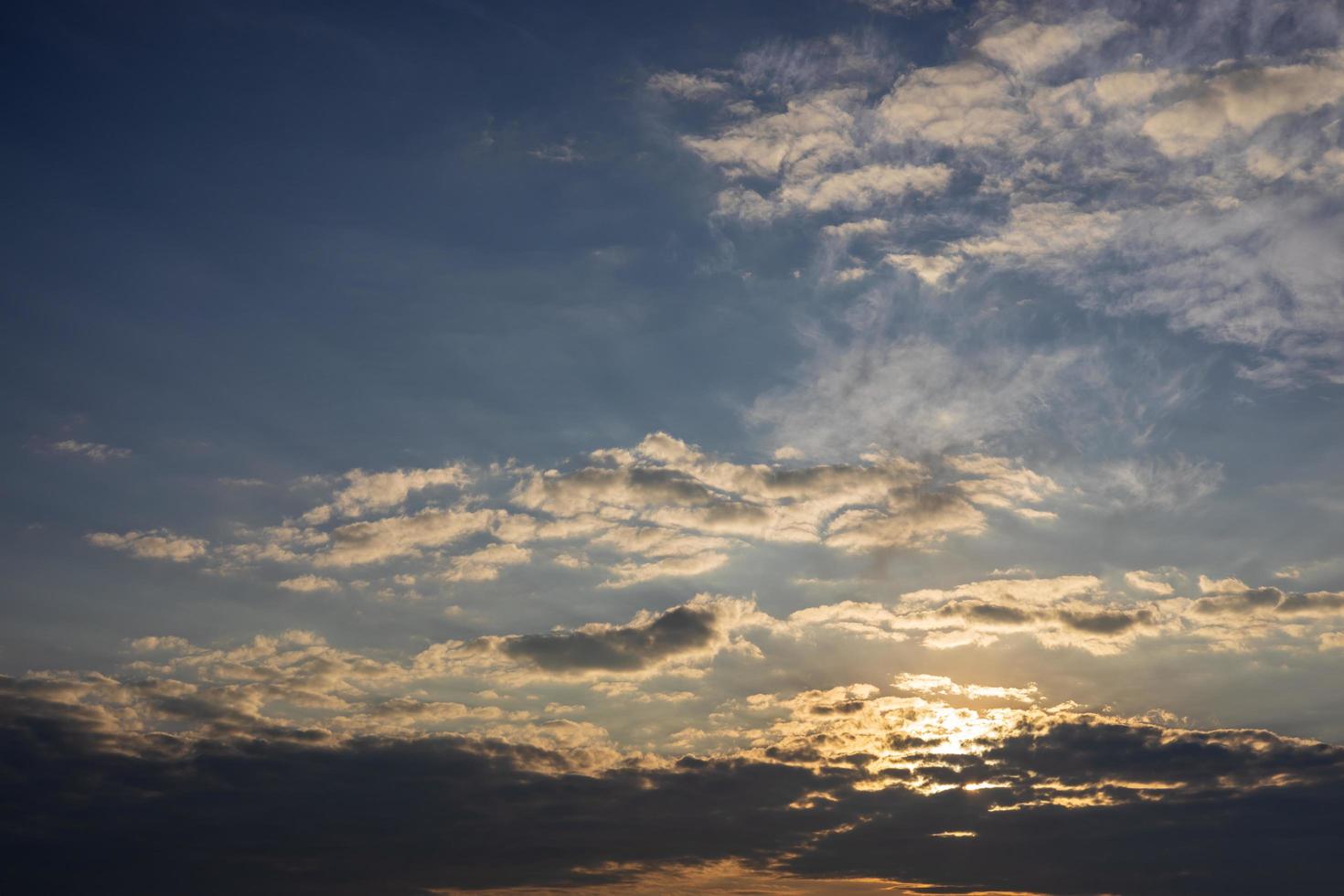 Scenery against a cloudy background with yellow sunlight passing through the blue sky. photo