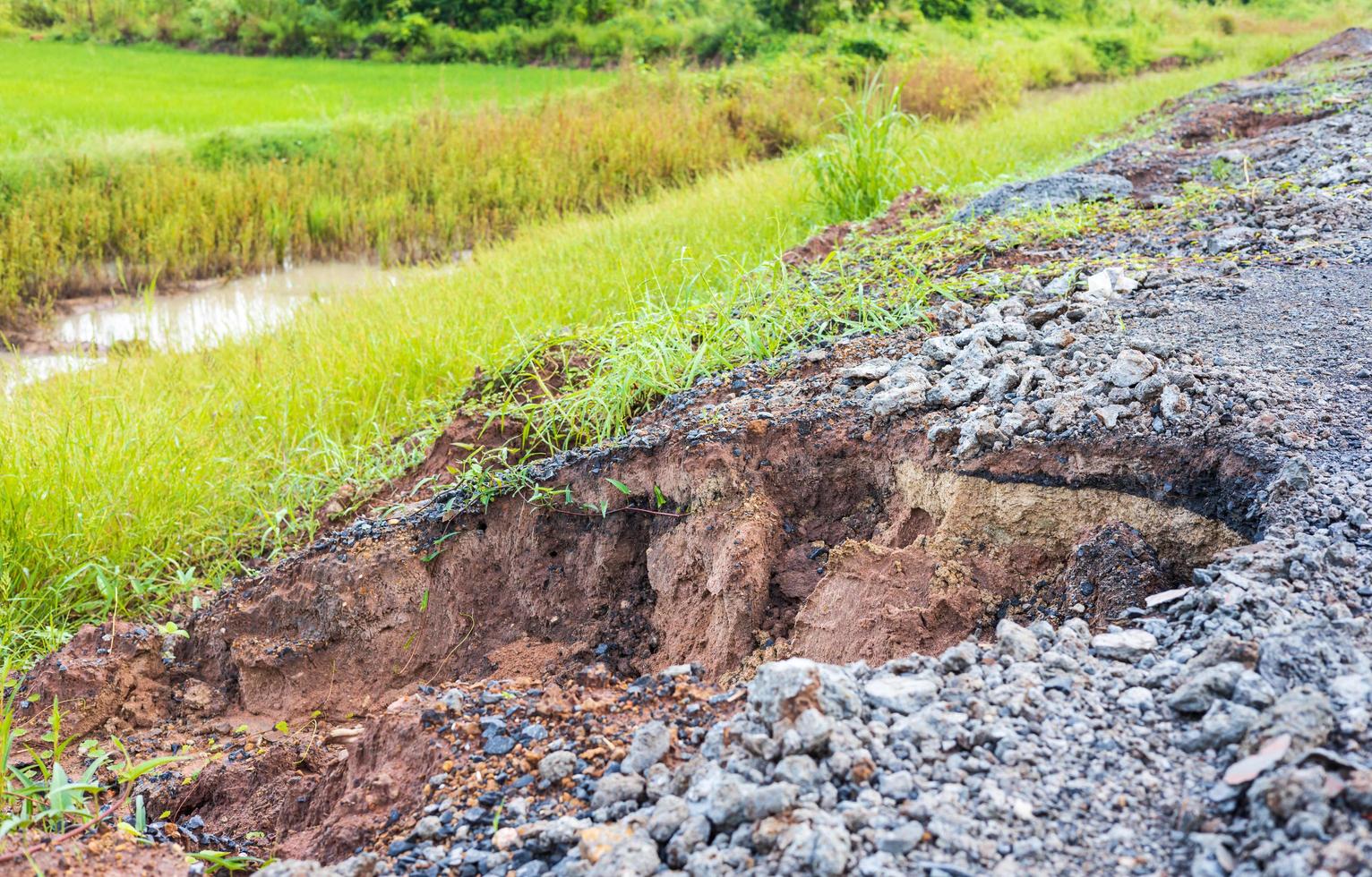 A side view of the stone paved road which was damaged into a pothole. photo