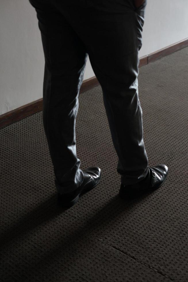 Man in Black Standing in a Room with Shadow photo