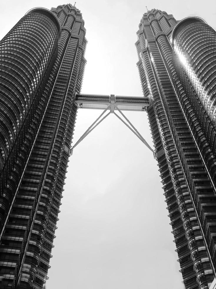 KUALA LUMPUR-FEB-02-28-2016, black and white picture vertical, dark sky above top of Petronas twin towers. February in Kuala Lumpur, Malaysia. photo
