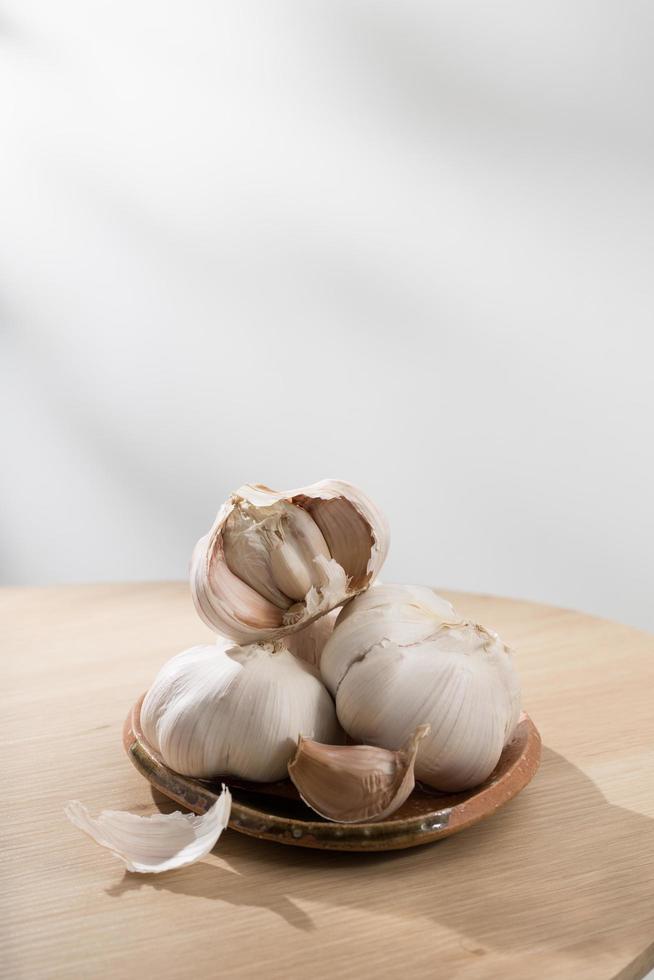 Garlic on wooden table photo
