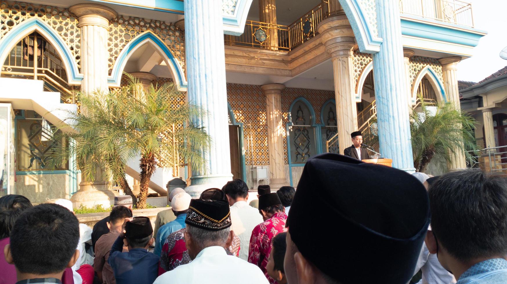 gresik, indonesia, 2022 - you can see people focusing on listening to lectures after carrying out the Eid al-Adha prayers photo