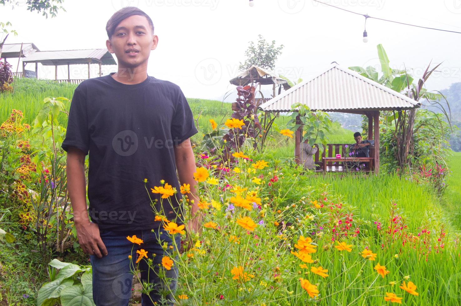 a man dressed in plain black in a park in Mojokerto, Indonesia photo