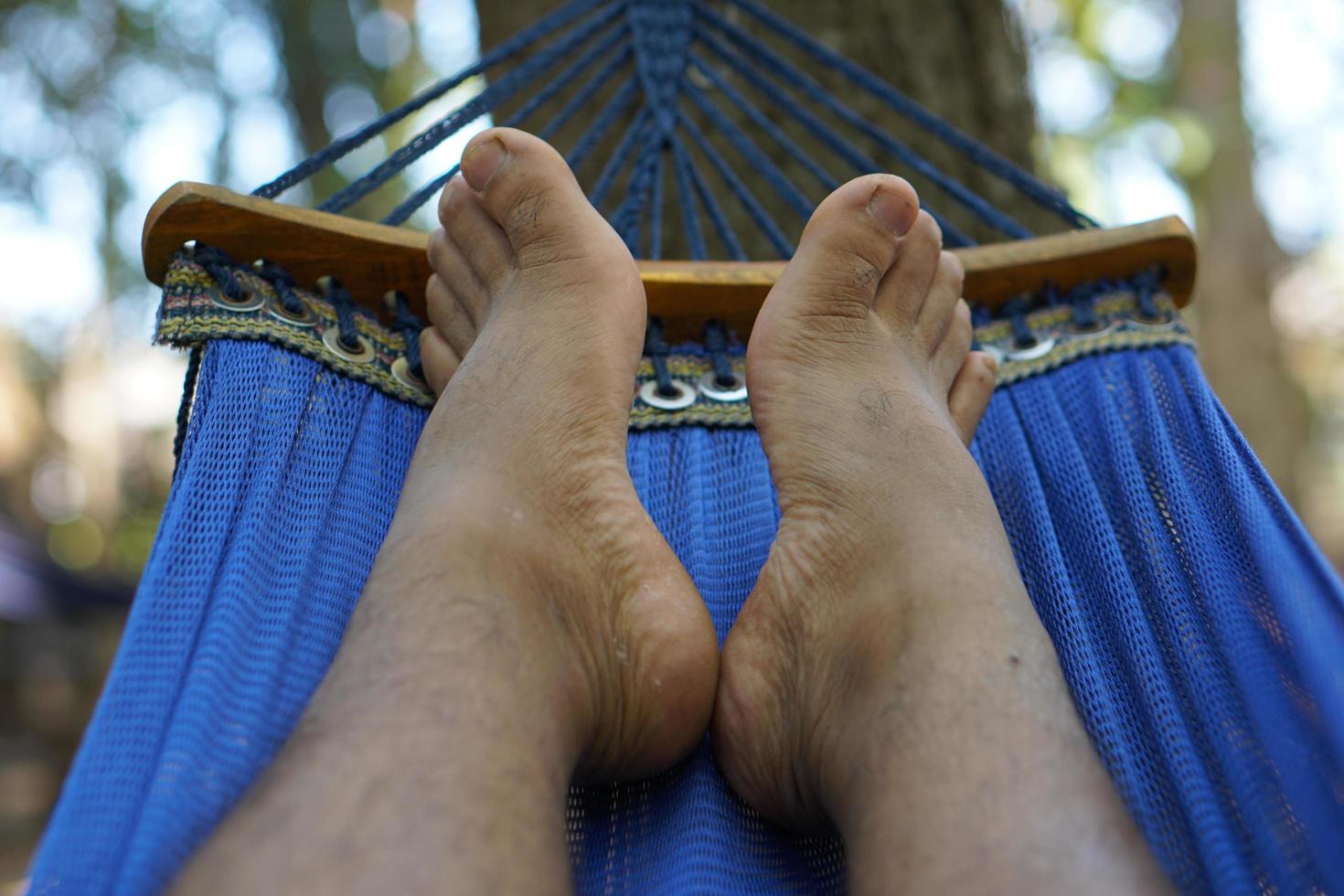 Man's feet lying on the bed on vacation photo