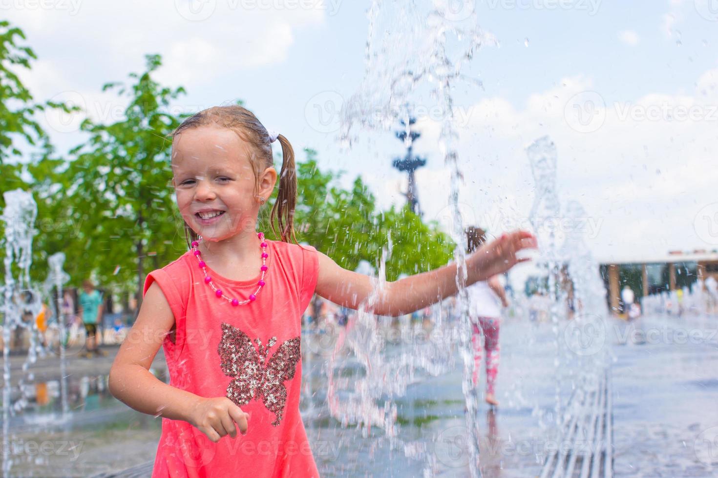 Adorable little girl have fun at hot sunny summer day photo