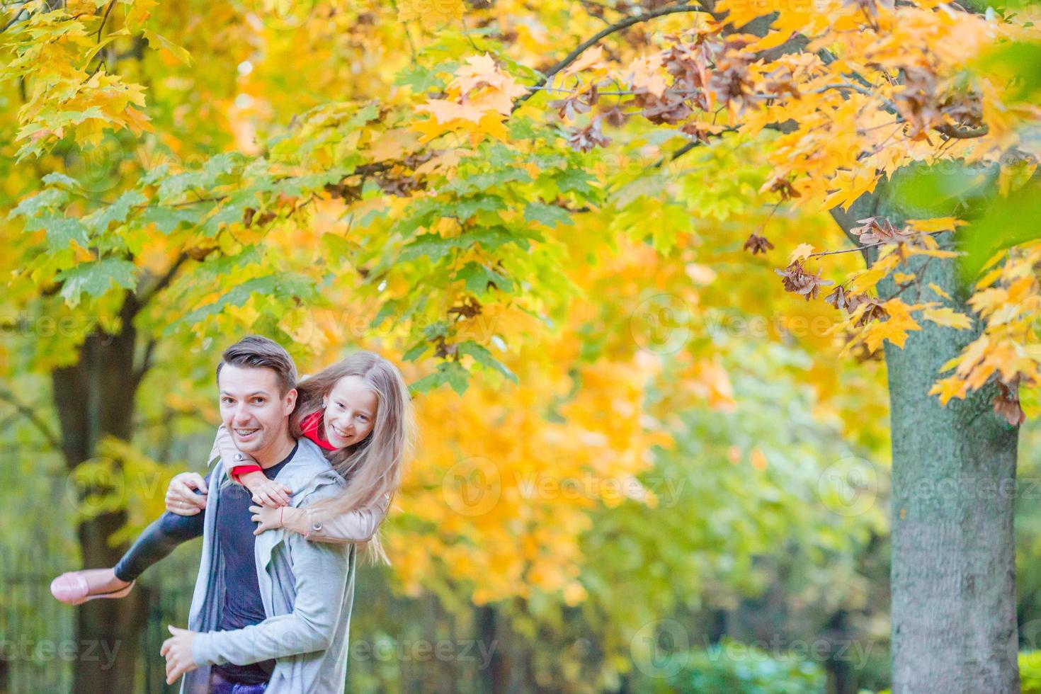 Father and his adorable little daughter outdoors on sunny autumn day photo