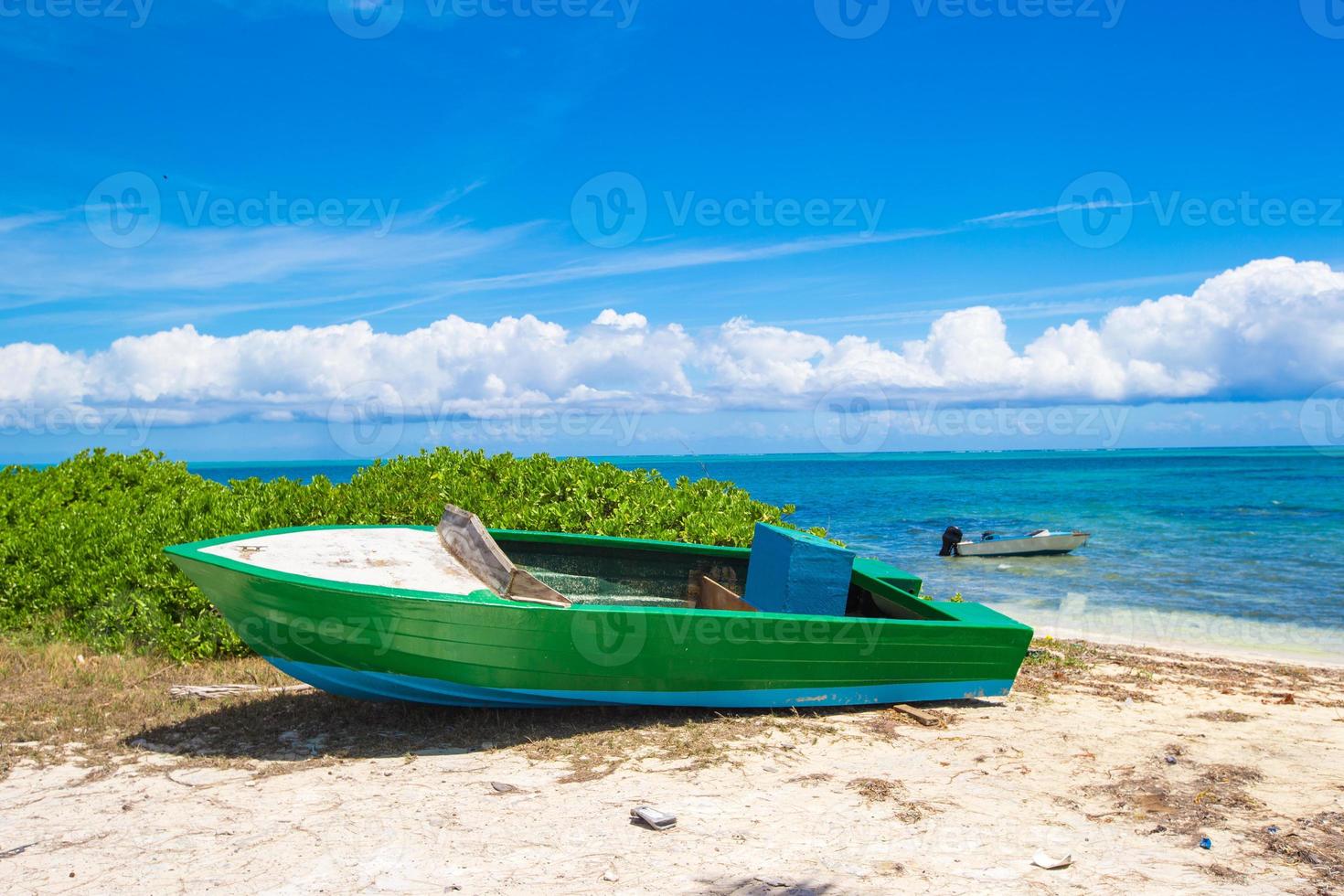Old fishing boat on a tropical beach at the Caribbean photo