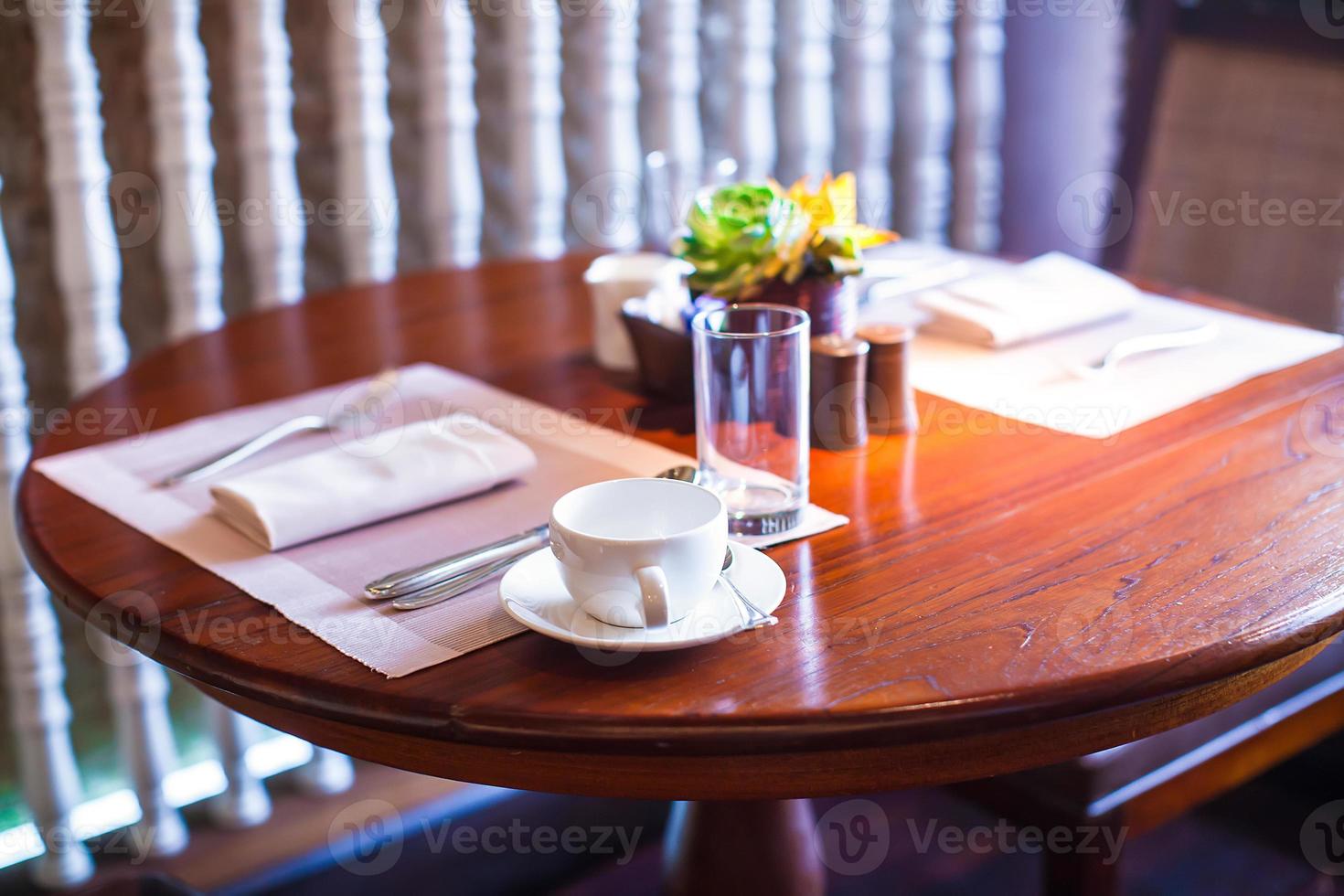 Served table for breakfast in luxury hotel with flowers photo
