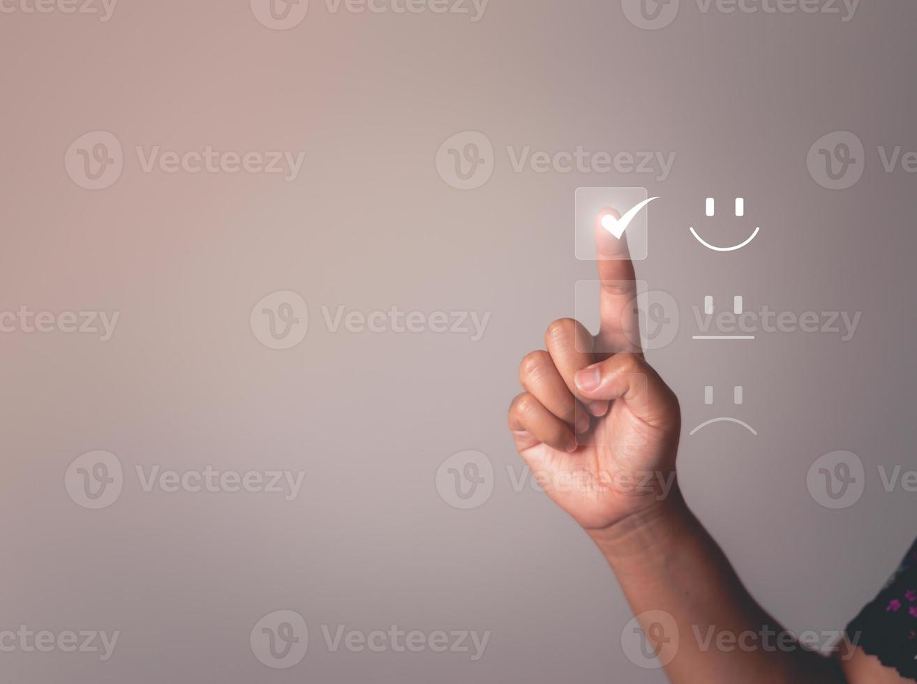 Business people are touching the virtual screen on the happy smile face icon to give satisfaction in service. rating very impressed. Satisfaction For the Customer service concept. photo