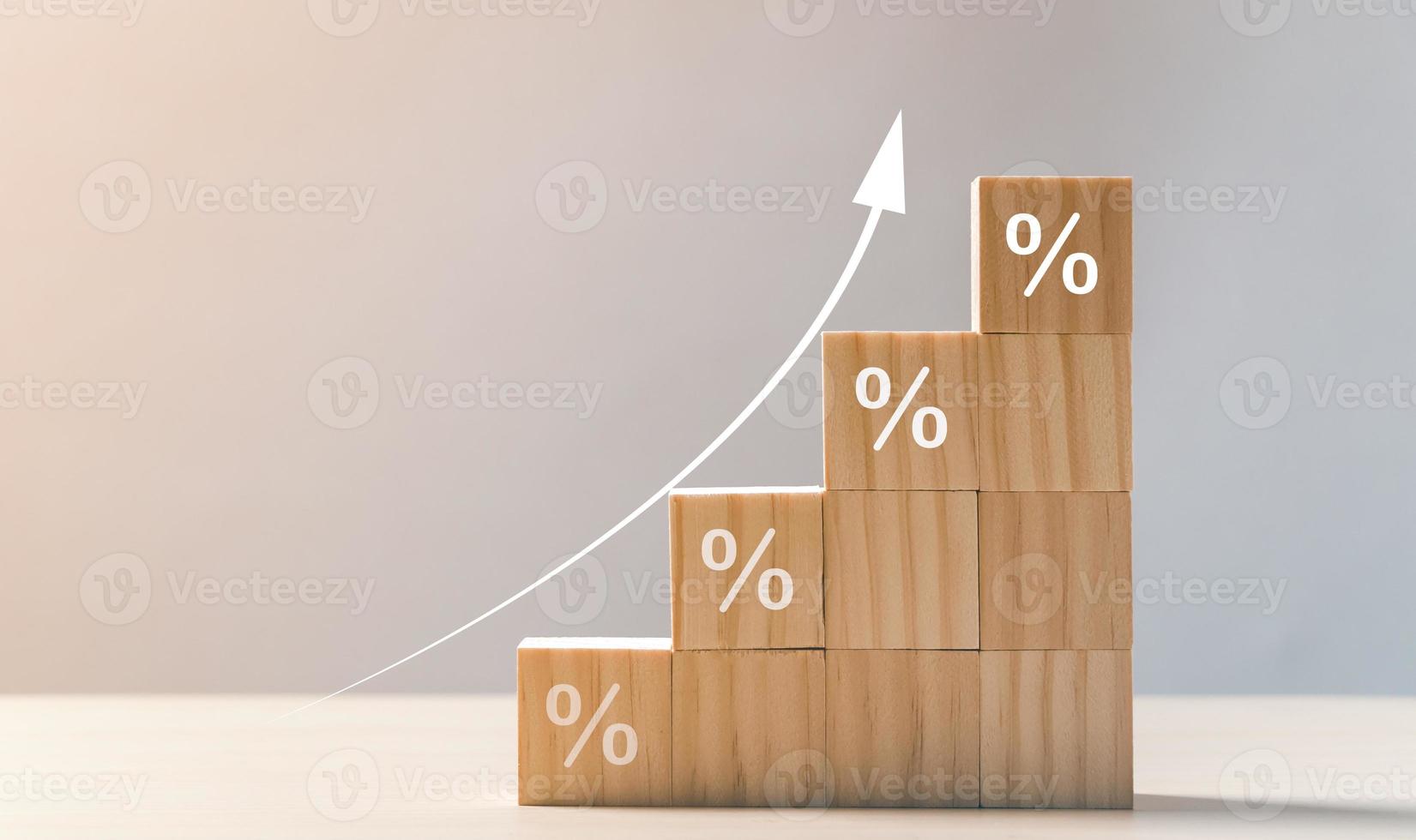 The economy is improving. Interest rate financial and mortgage rates concept. Wooden blocks with Icon percentage symbol and arrow pointing up. photo
