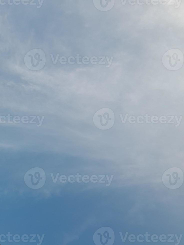 Beautiful white clouds on deep blue sky background. Large bright soft fluffy clouds are cover the entire blue sky. photo