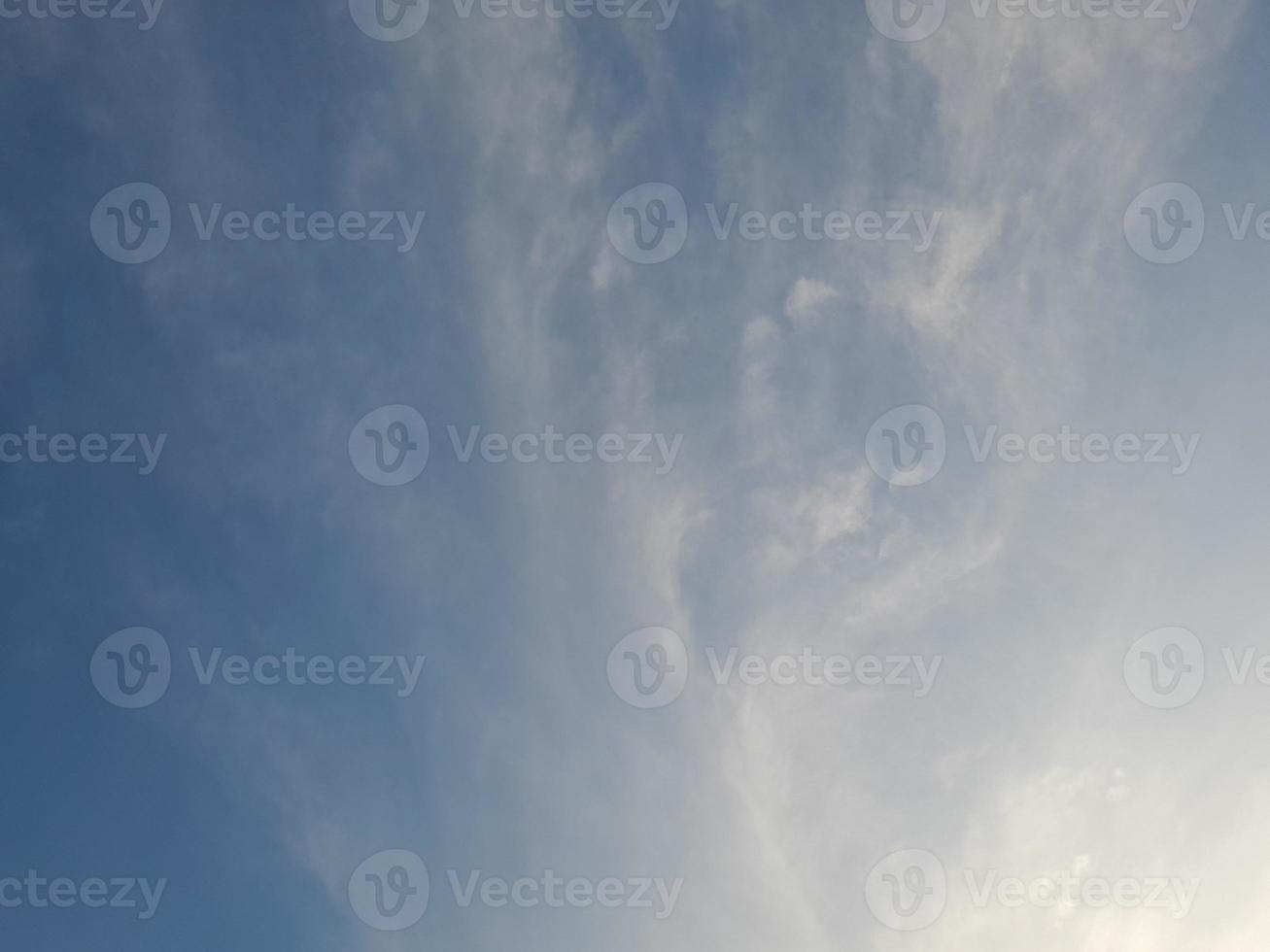 Beautiful white clouds on deep blue sky background. Large bright soft fluffy clouds are cover the entire blue sky. photo