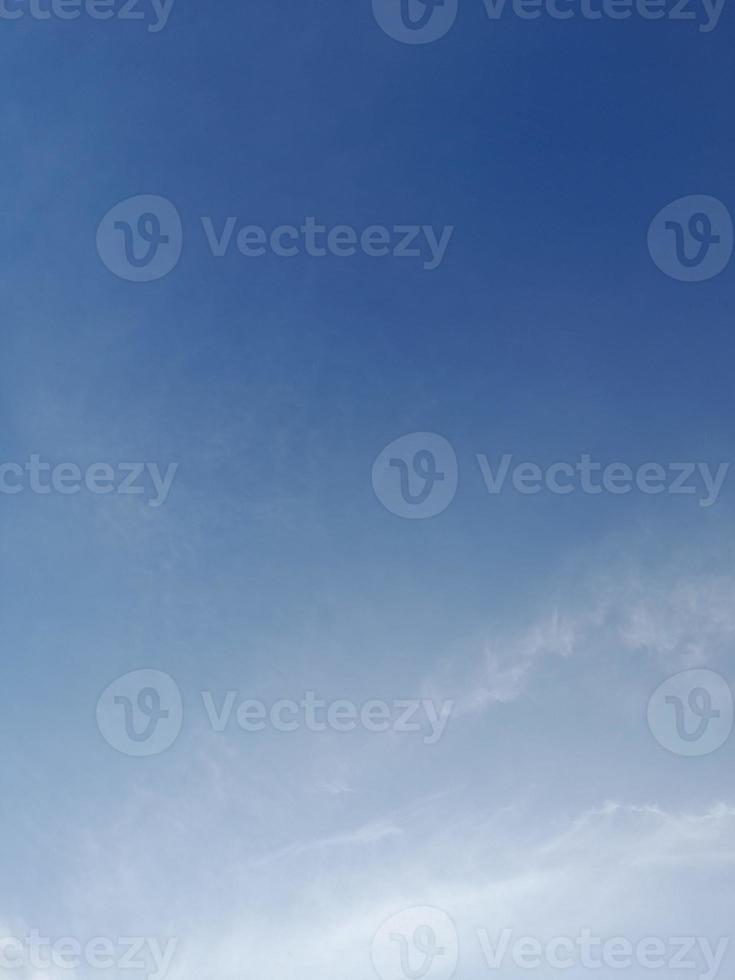 Beautiful white clouds on deep blue sky background. Large bright soft fluffy clouds are cover the entire blue sky. photo