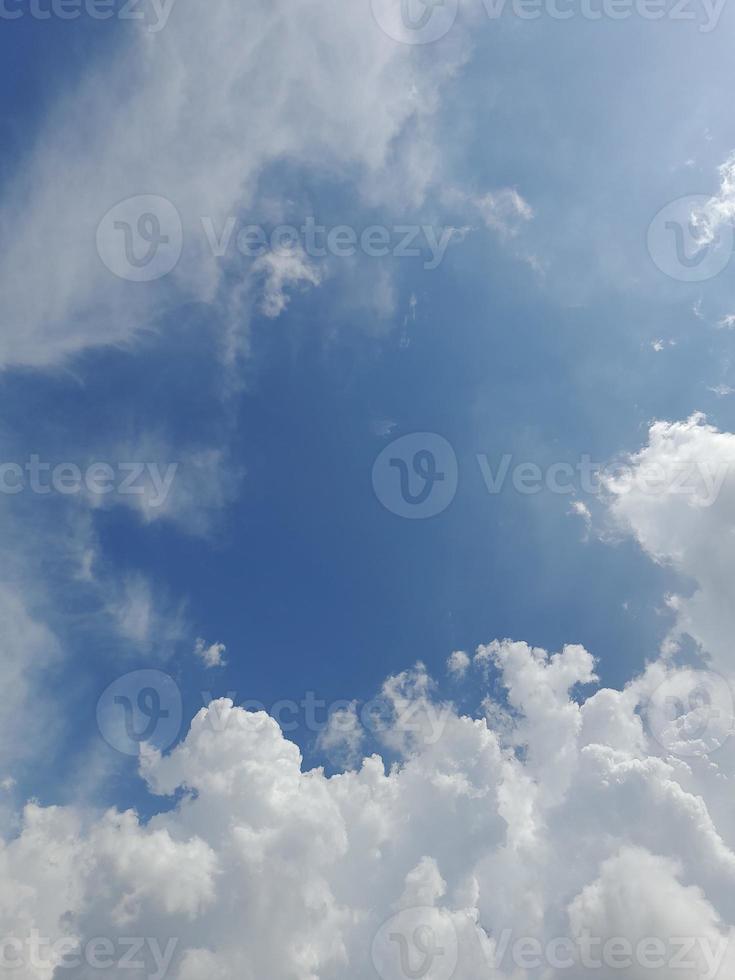 Beautiful white clouds on deep blue sky background. Large bright soft fluffy clouds are cover the entire blue sky. photo