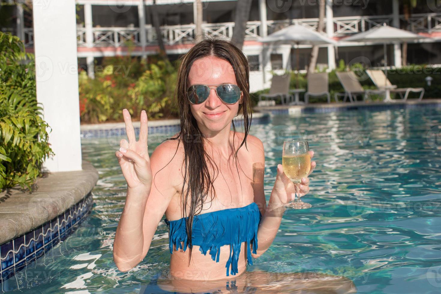 Young woman enjoying vacation in the pool photo