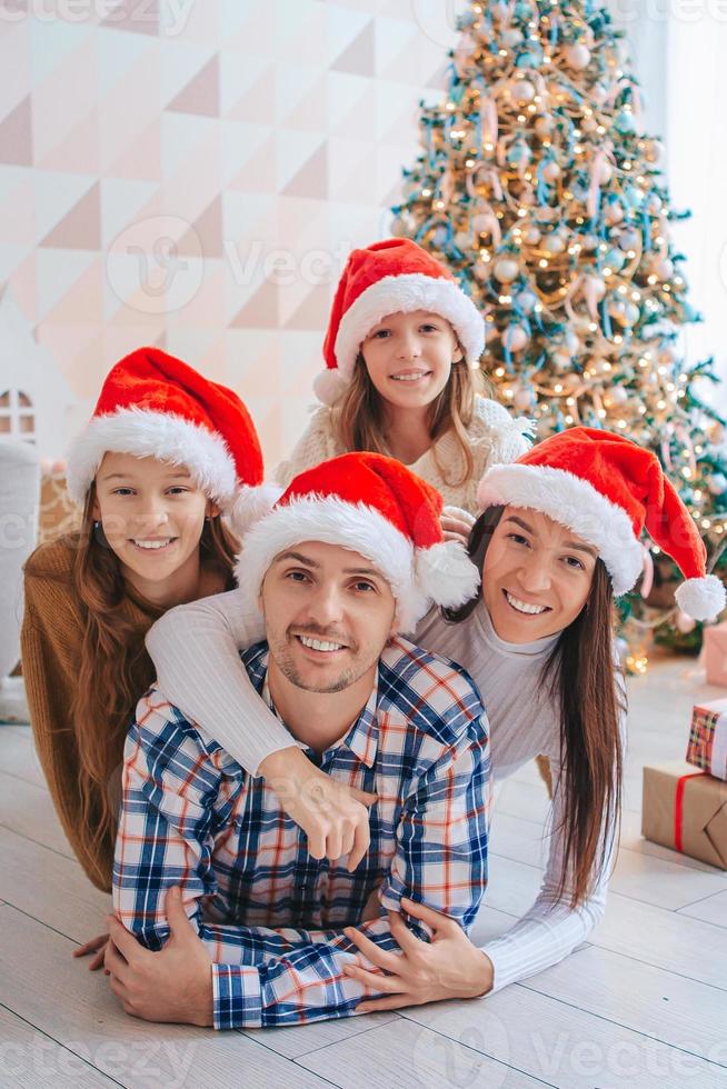 Happy young family with kids holding christmas presents photo