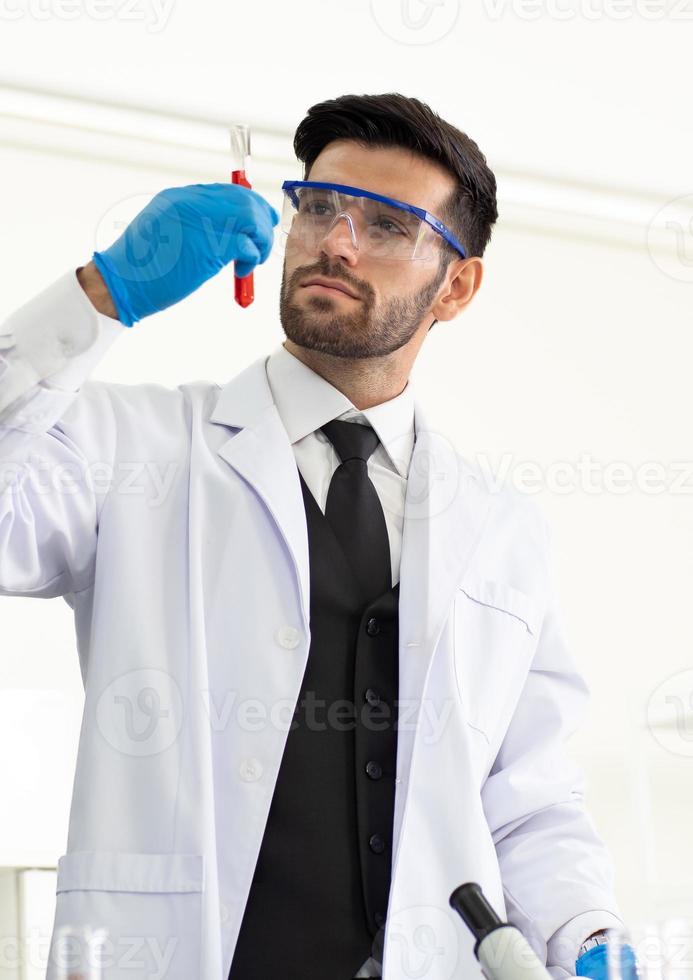 Male scientist working on chemistry analyzing in medical research and development laboratory. Doctor, science expertise study and experiment advanced medicine in high tech scientific innovation lab. photo