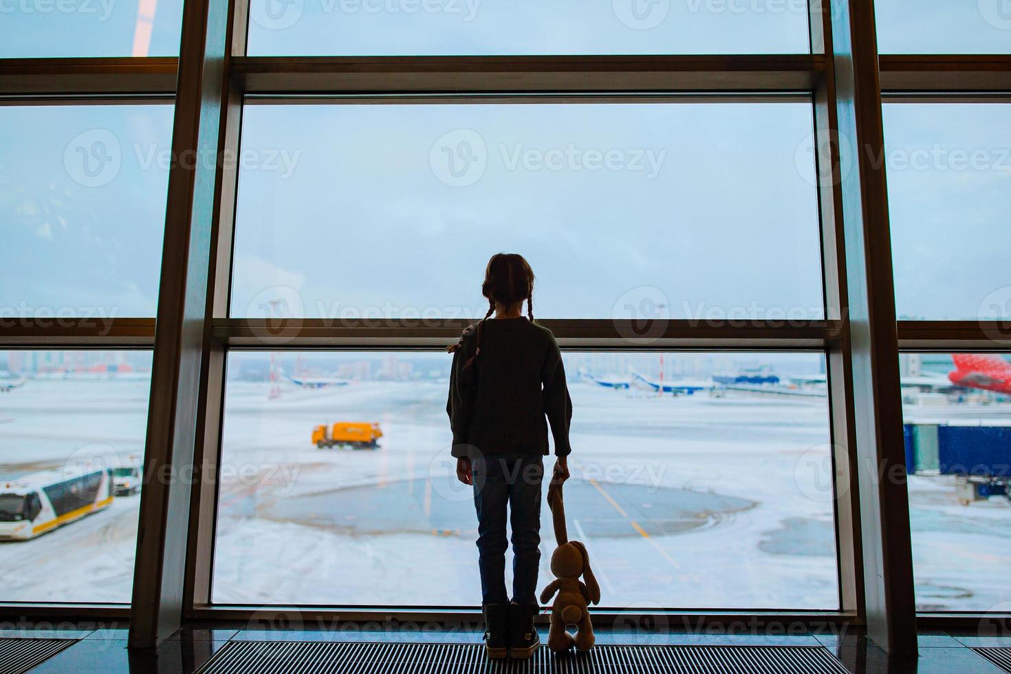 Little kid in airport waiting for boarding photo