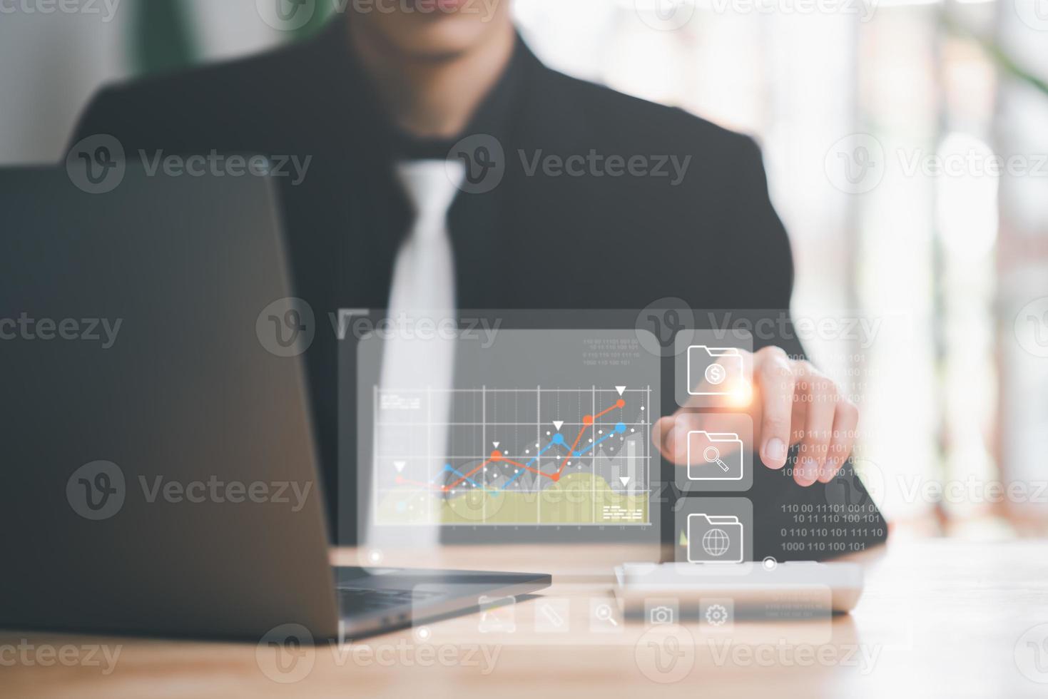 Businessman calculating numbers in corporate financial online document,with calculator ,analysis of company financial data ,planning to assess and review the budget ,concept of finance and investment photo
