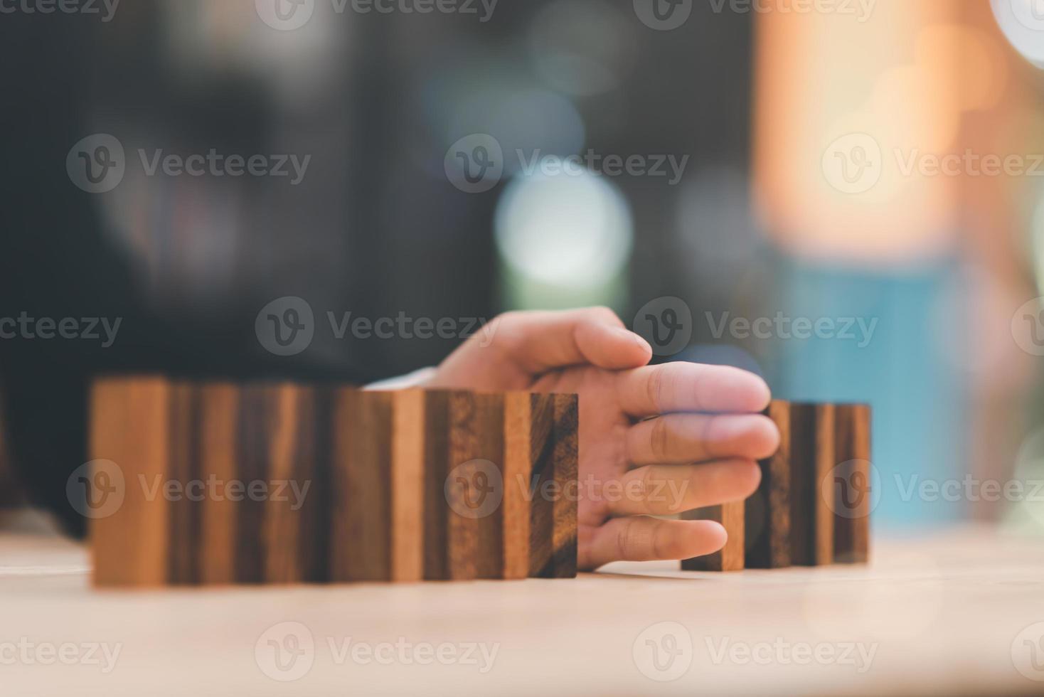 Human hands blocking wooden sticks,Financial risk management and strategic planning through data analysis for continuous improvement Visionary Decisions for Leadership Success photo