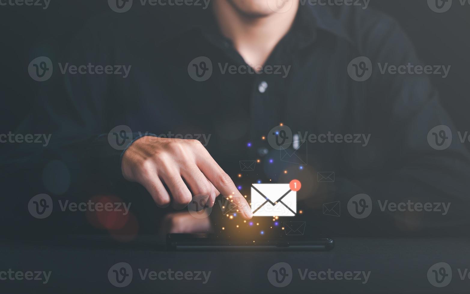 man reading electronic mail ,Email marketing and newsletter concept,Digital communication with email messages,Sending and receiving messages online with the email icon,electronic news alerts photo