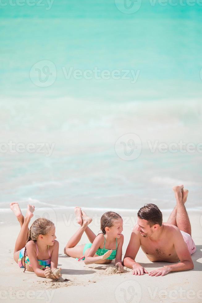 Father and little kids enjoying beach summer tropical vacation photo
