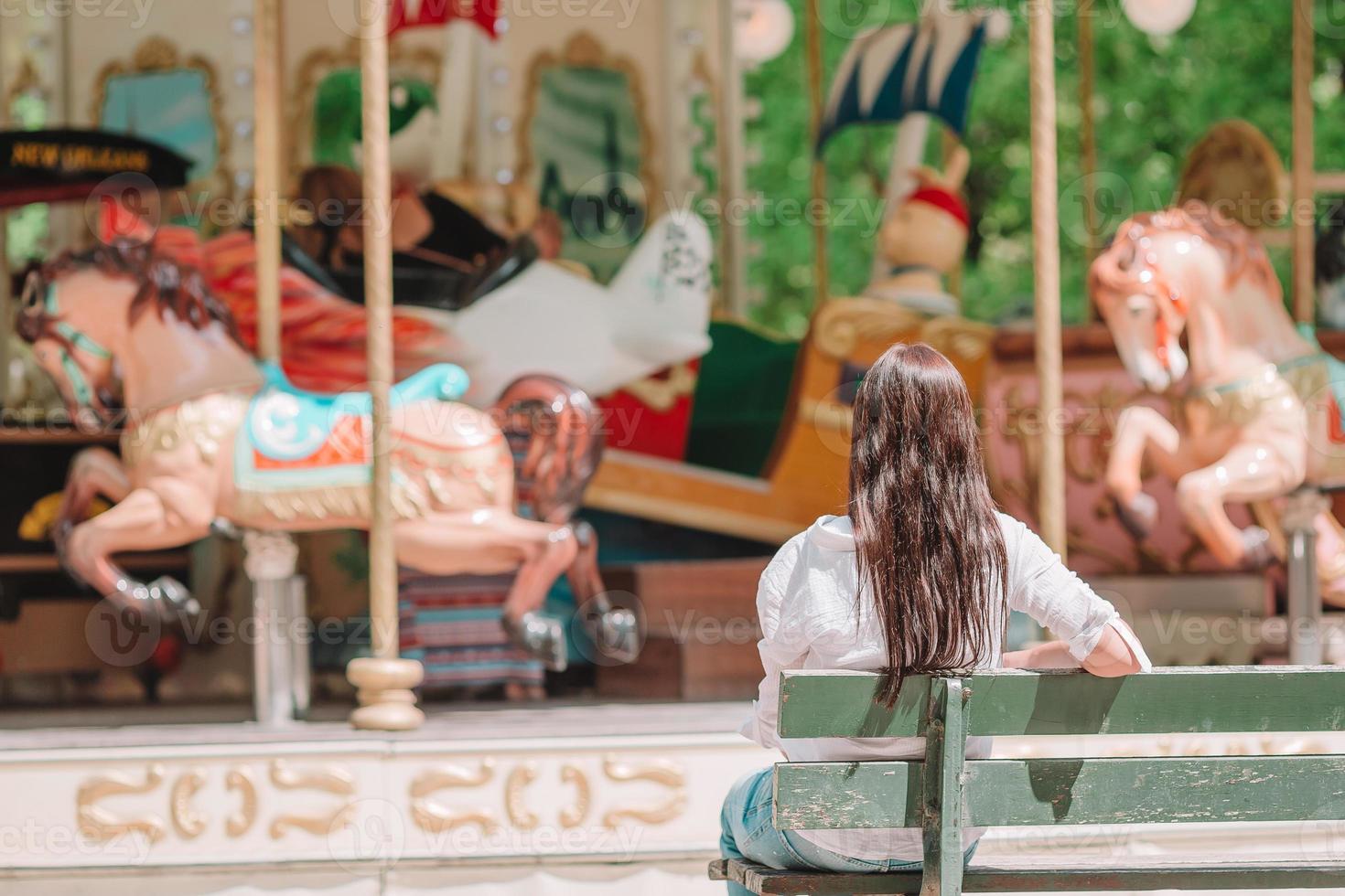 Beautiful woman near the carousel outdoors in Paris photo