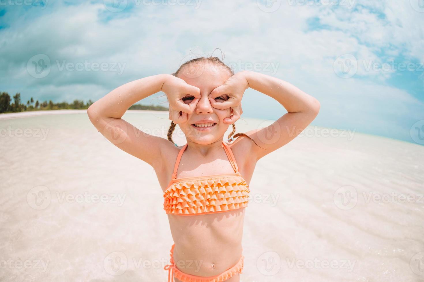 Cute little girl at beach during summer vacation photo