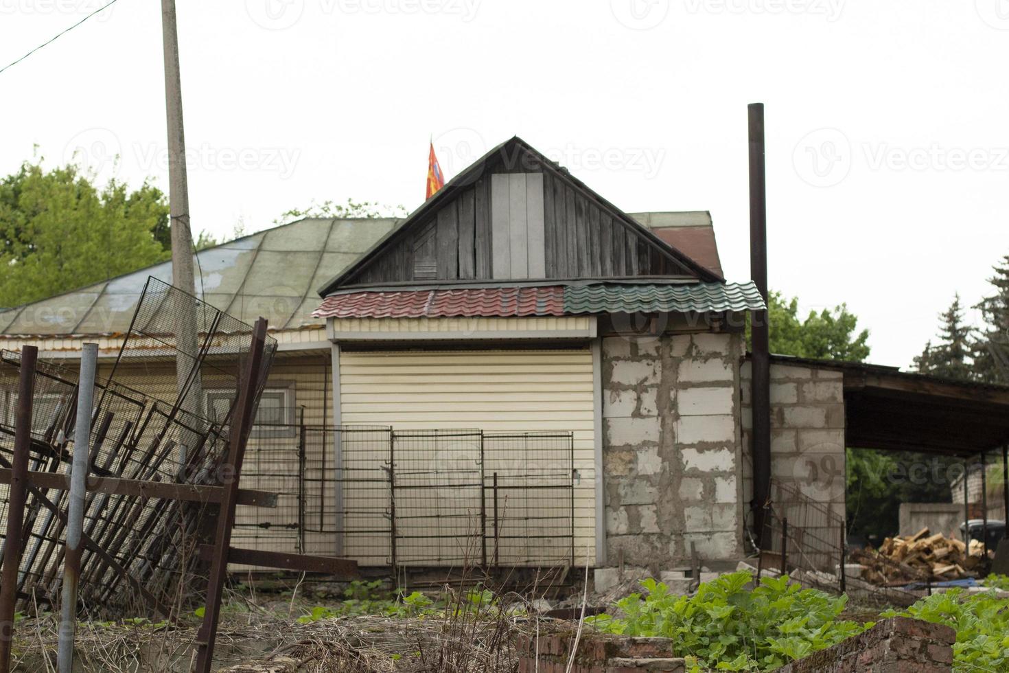 House in village. Summer in countryside. Simple house to live outside city. photo