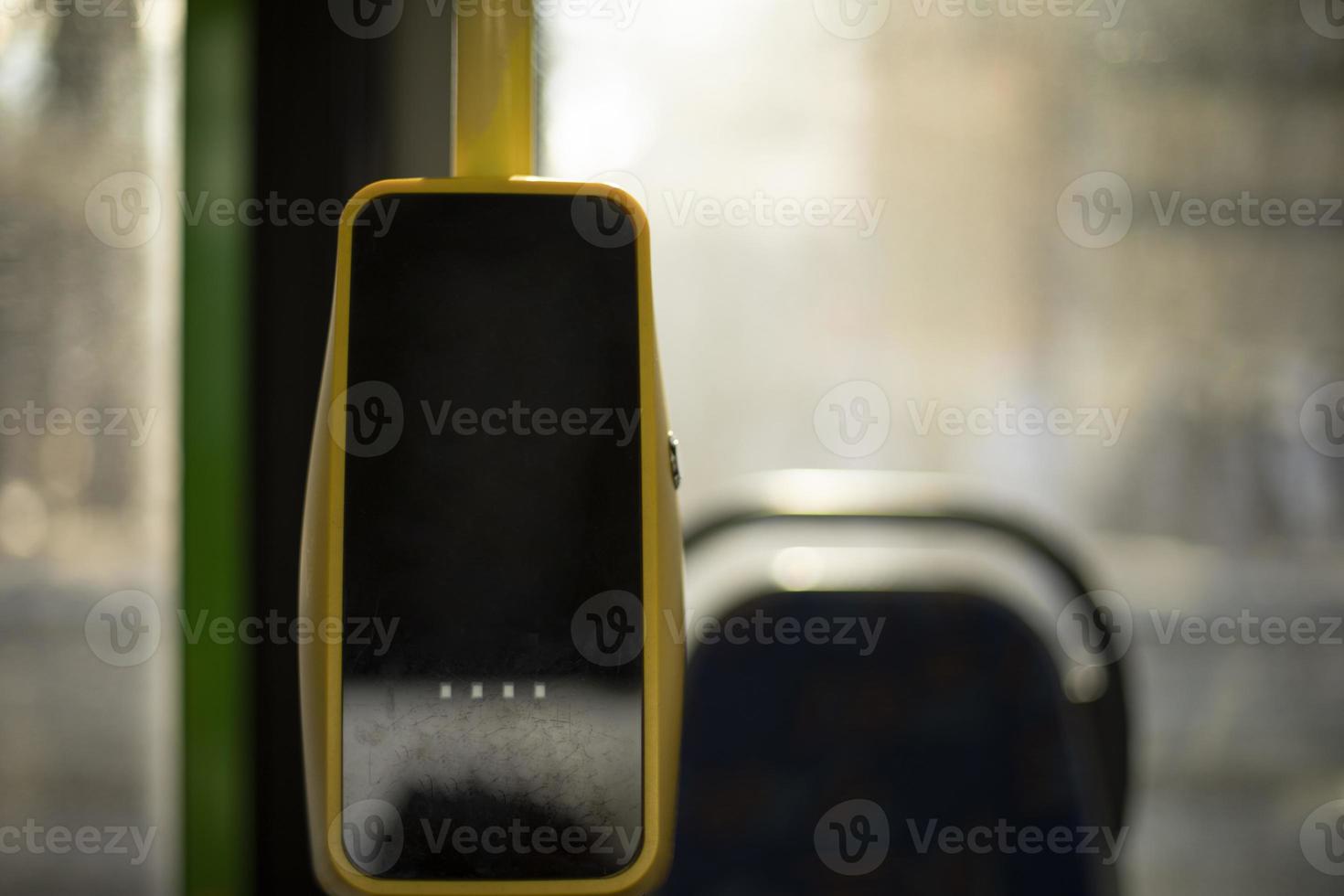 Devices for paying for bus fares. Interior of bus. Electronic cashier. NFC sensor for payment. photo