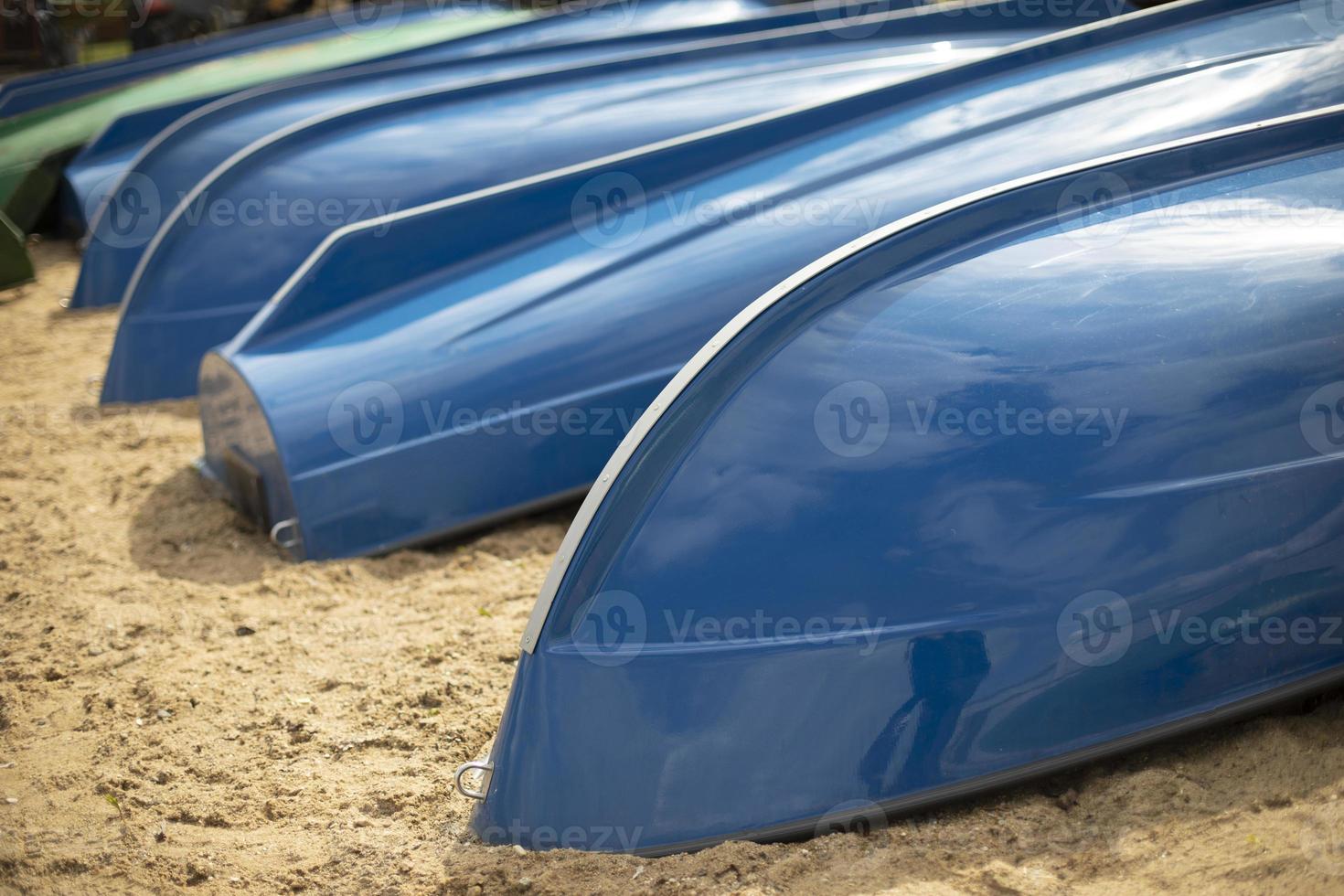 Blue boats on beach. Boat station on lake. photo