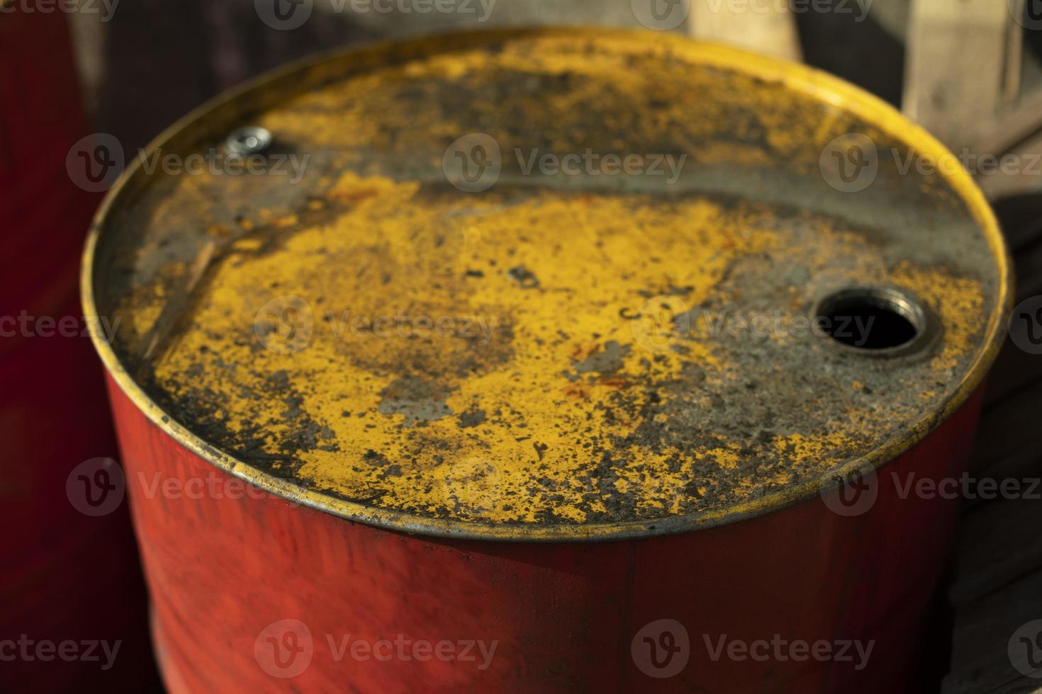 Fuel barrel with yellow lid. Red fuel tank. Old canister. photo