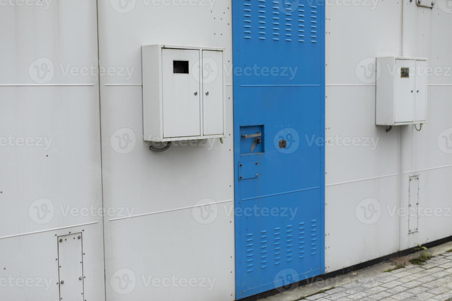 Door to electrical panel. High voltage. Technical room. Electrical equipment in building. Danger zone. photo