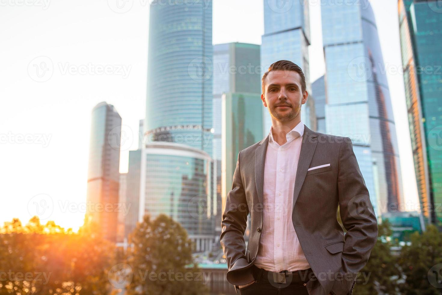 Young caucasian man holding smartphone for business work. photo