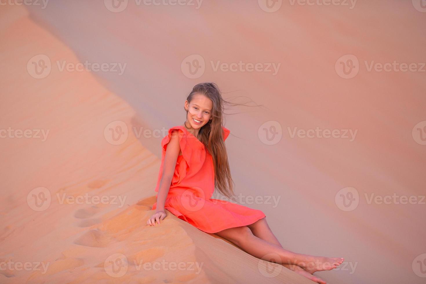 Girl among dunes in Rub al-Khali desert in United Arab Emirates photo