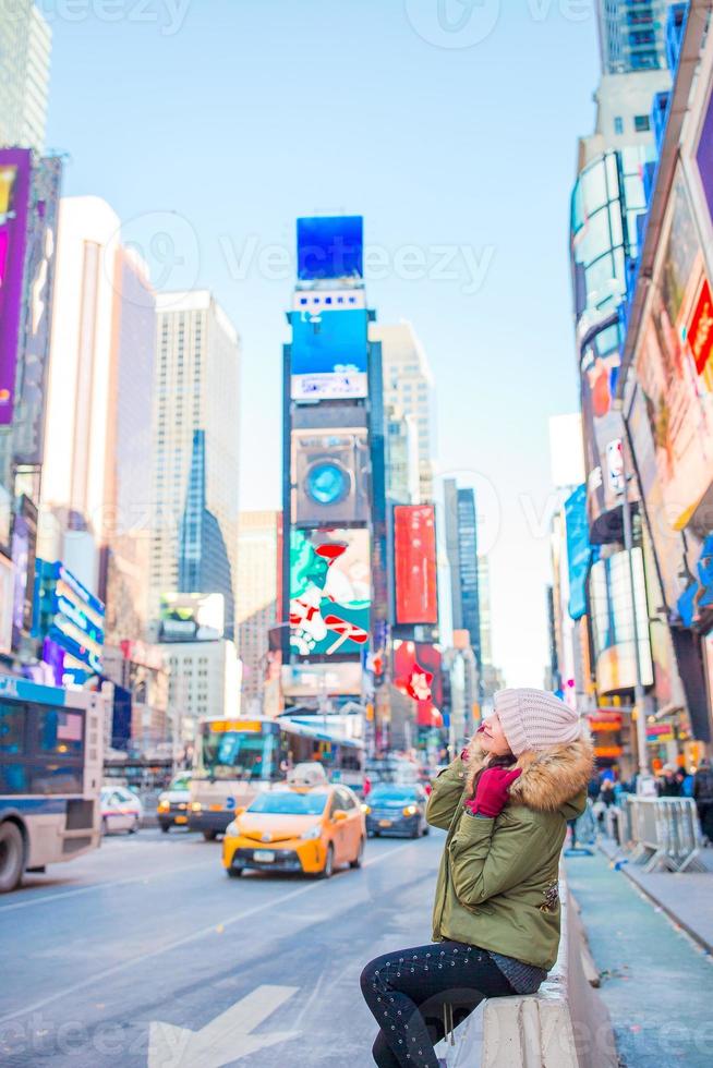 New York City woman as Times Square tourist or young happy woman visiting. Beautiful young happy smiling girl on Manhattan, New York City, New York, USA. photo