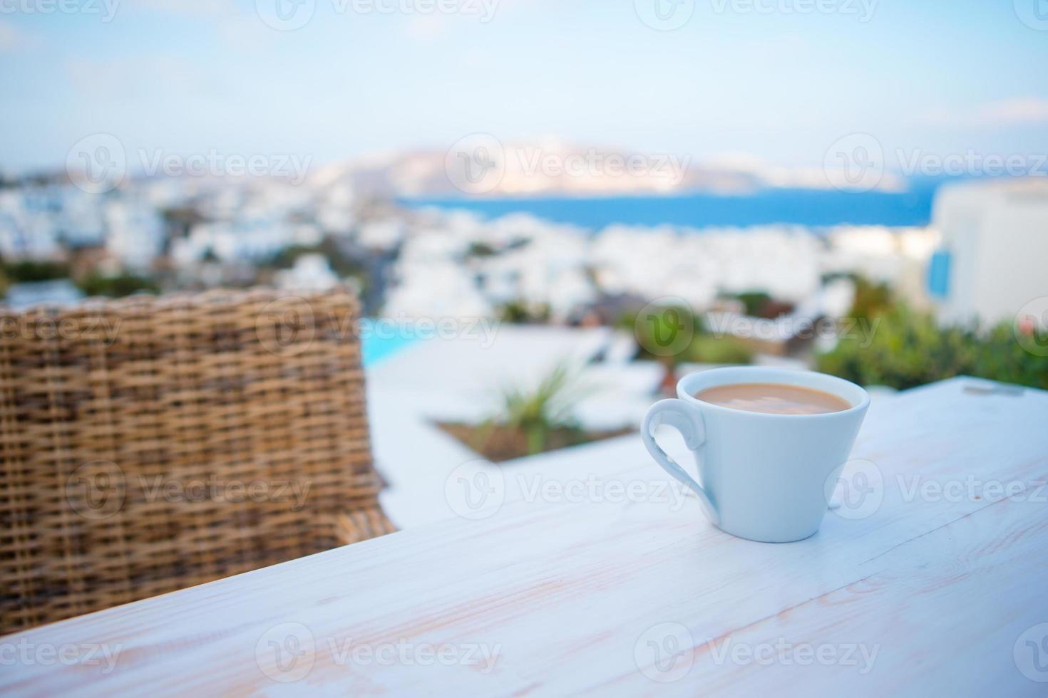 Coffe on the table on summer empty openair cafe with sea view photo