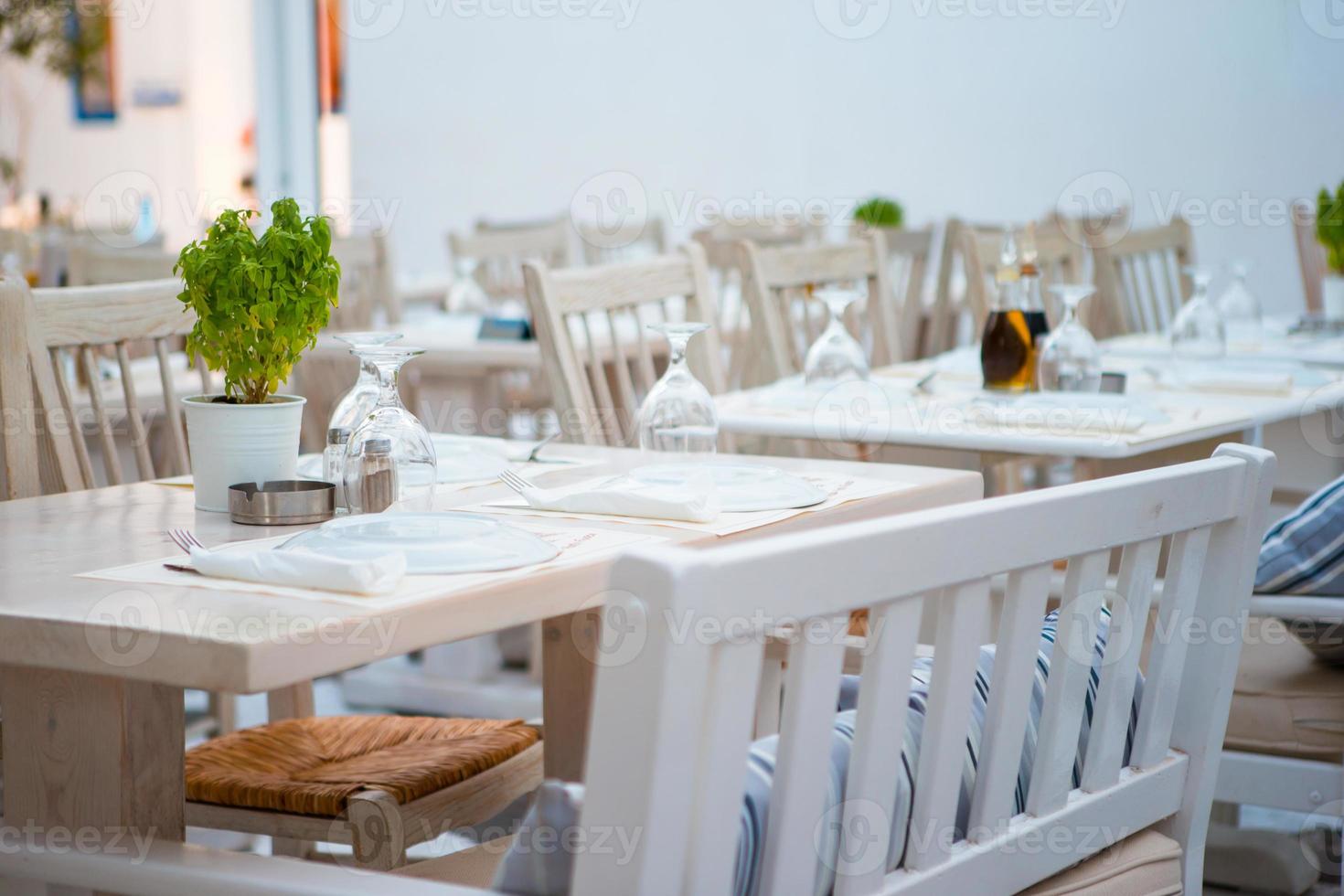 Summer empty openair cafe at greek city photo