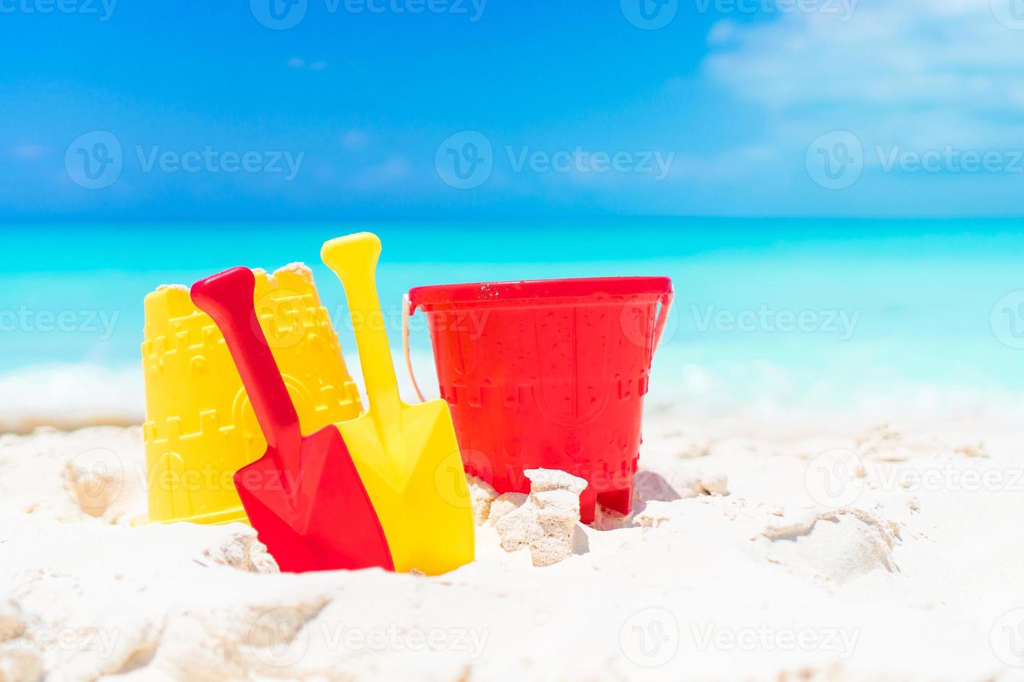 Kid's beach toys on white sandy beach photo