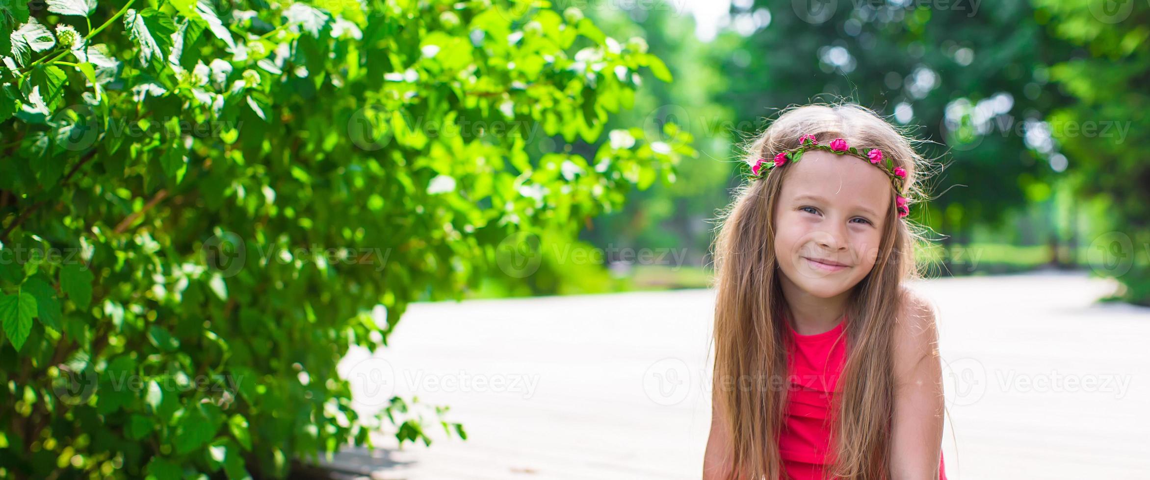 Portrait of adorable little girl on a warm summer day photo