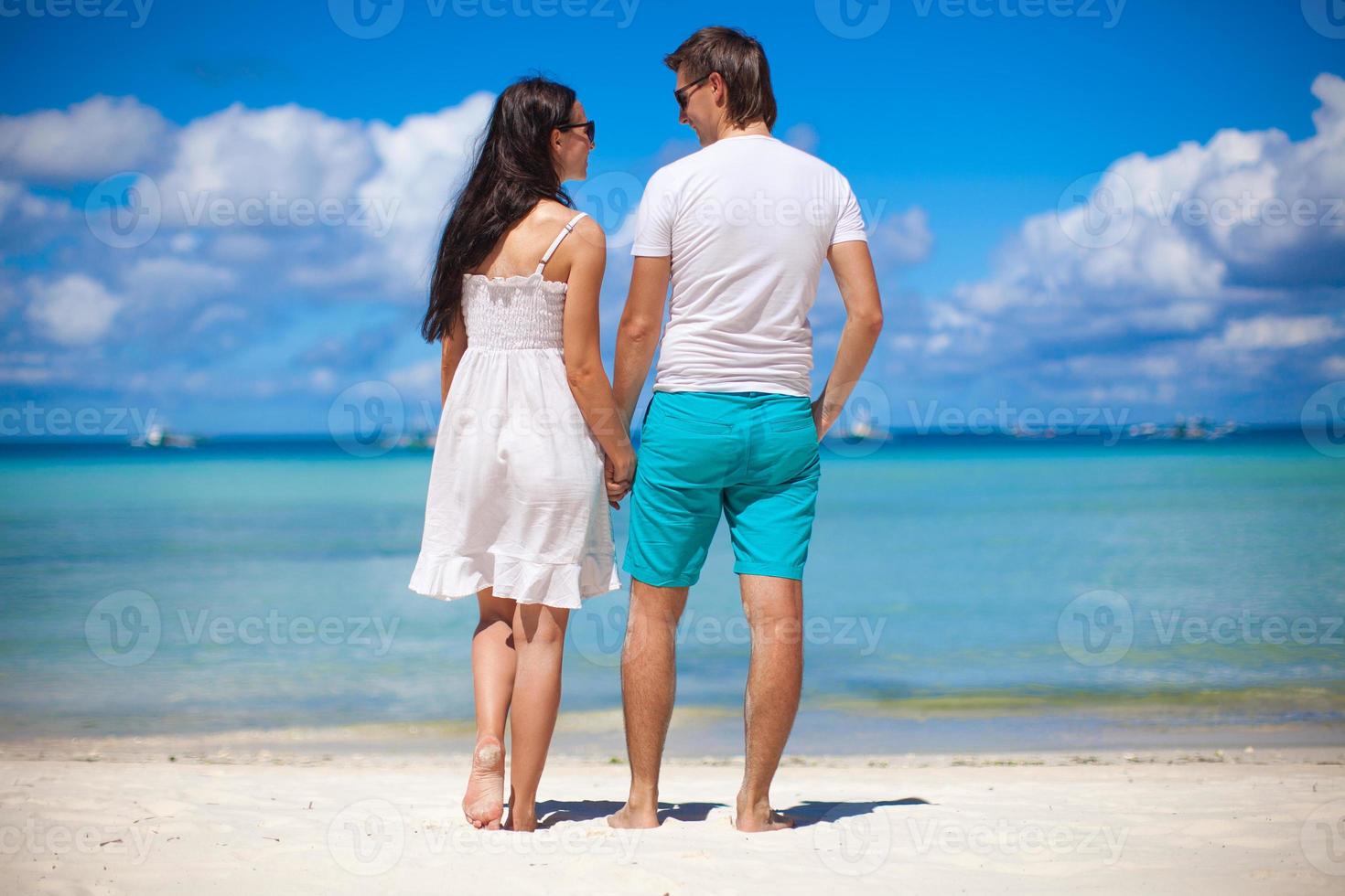 Romantic couple at tropical beach in Philippines look at the sea photo