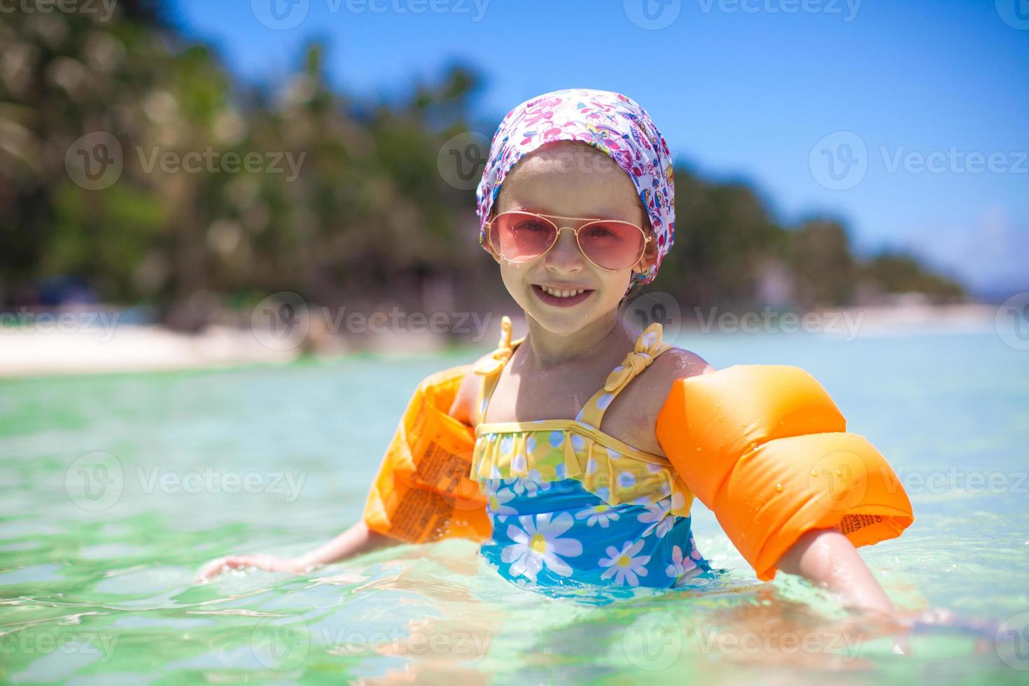 Adorable little girl in the sea have fun photo