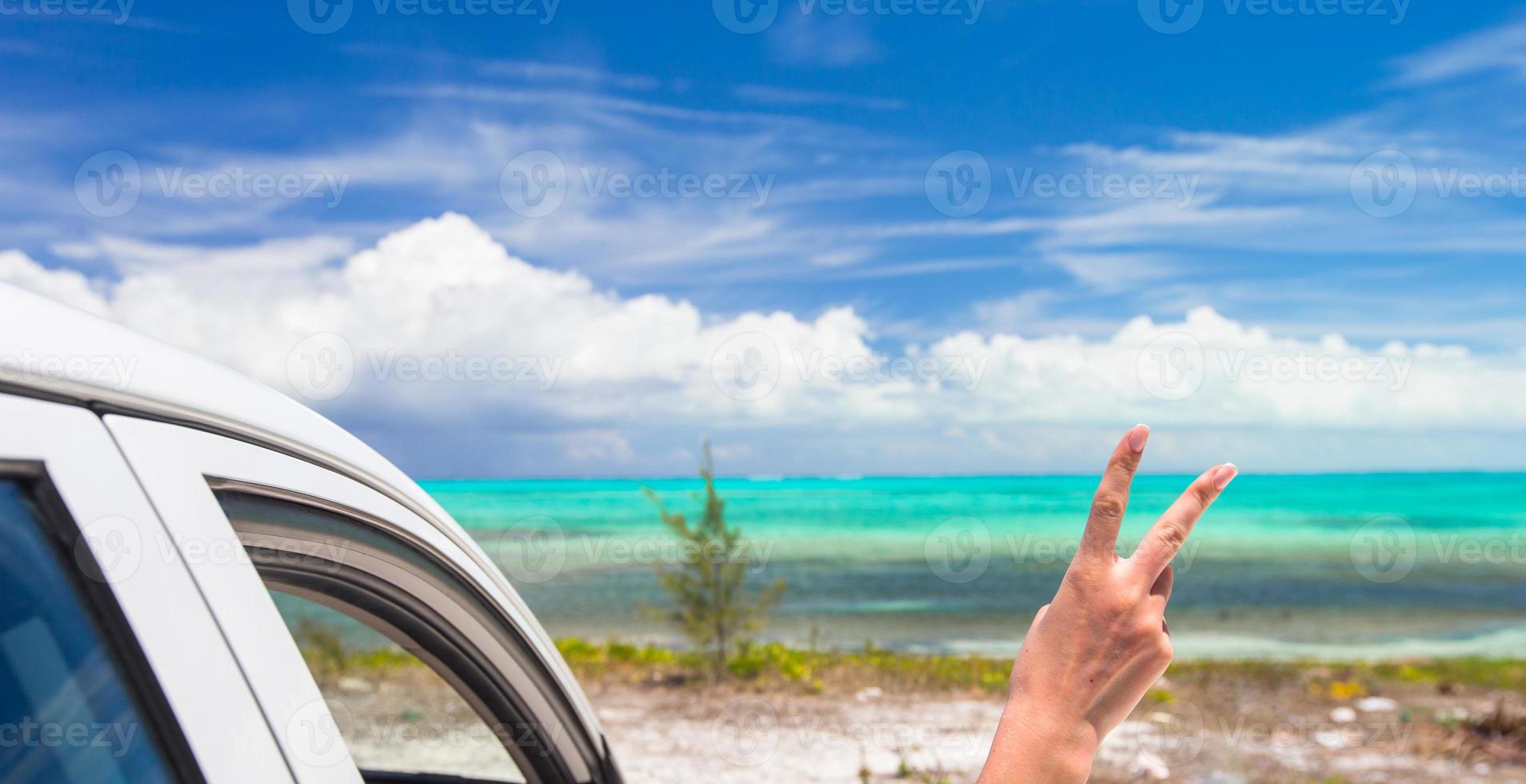 Close up raised hands at perfect beach photo