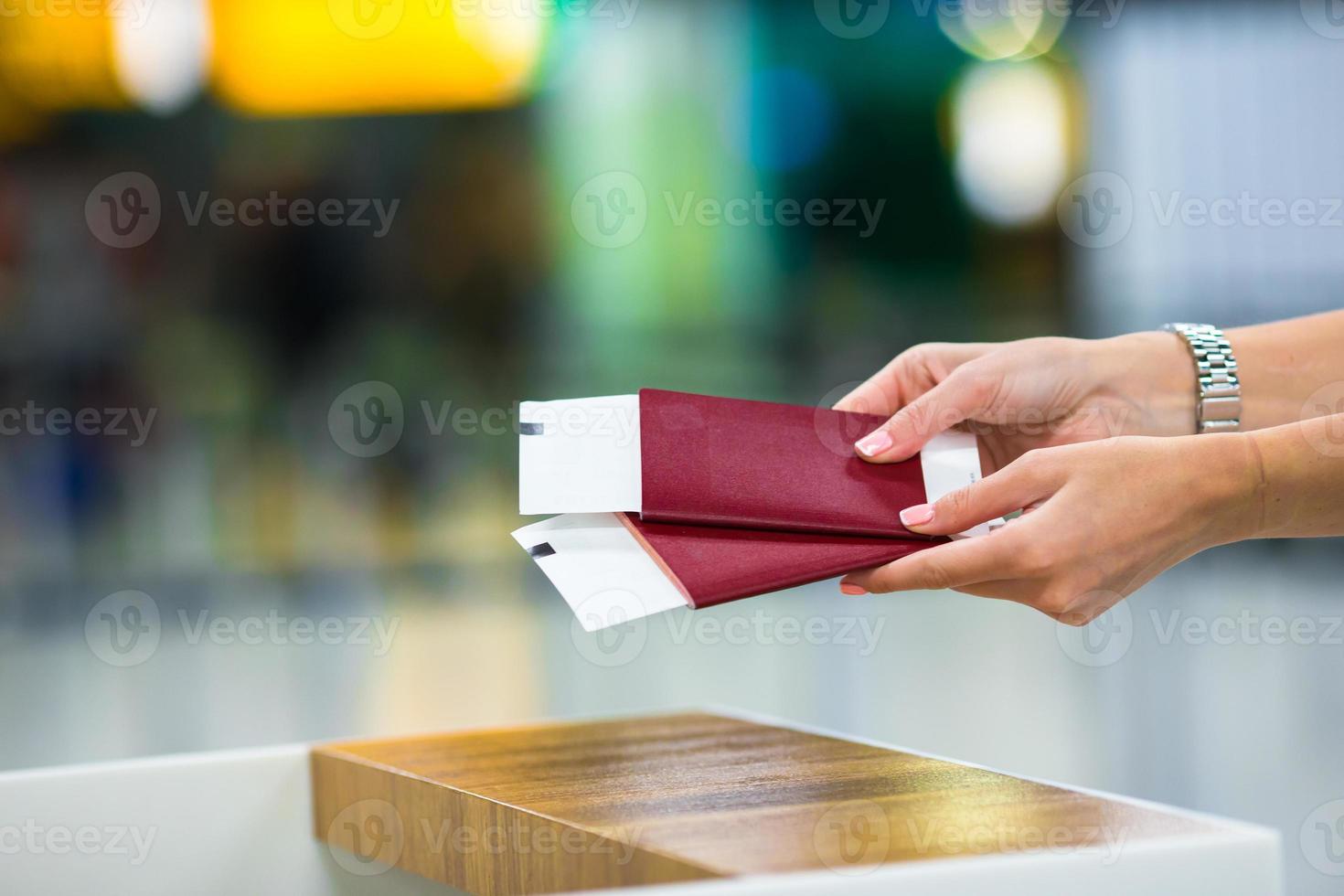 Closeup passports and boarding pass at the reception area in airport inside photo