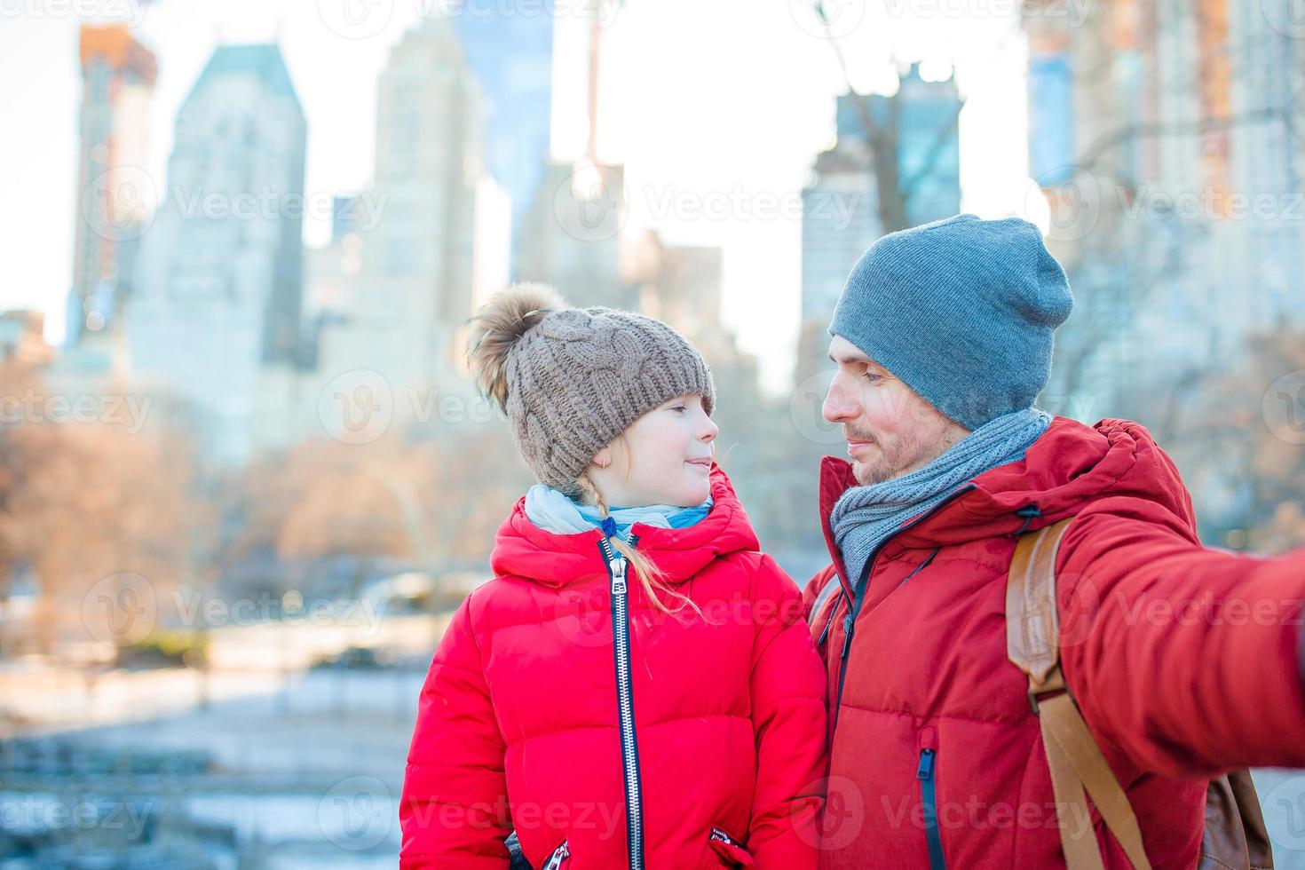 Family of dad and little kid taking selfie photo in Central Park at New York City
