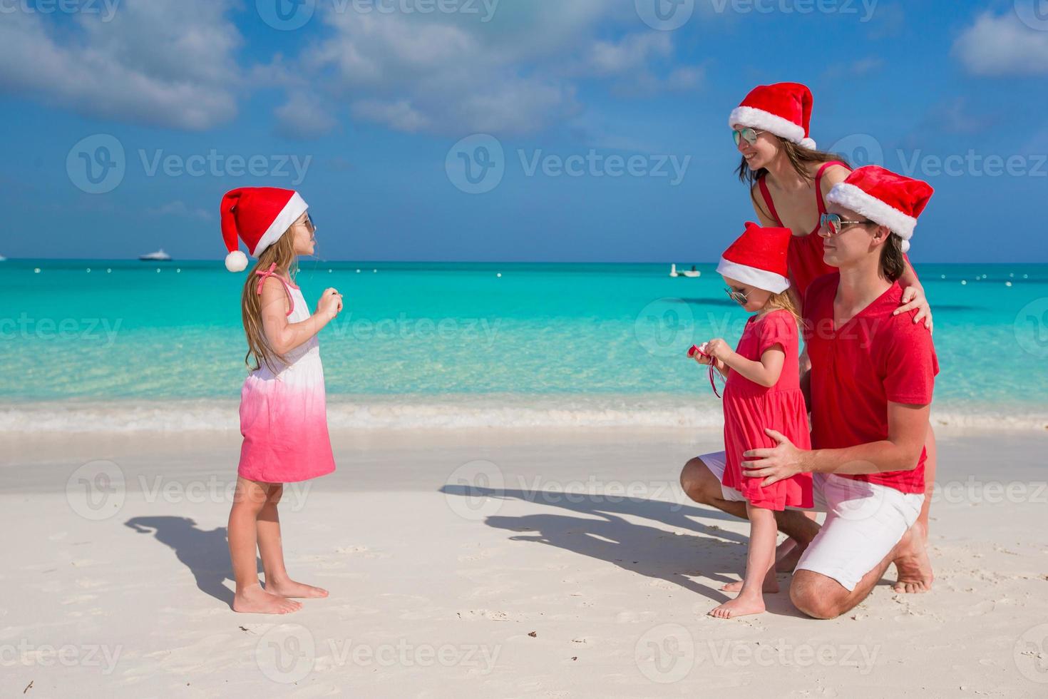 Little girl making photo on phone of her family at the beach